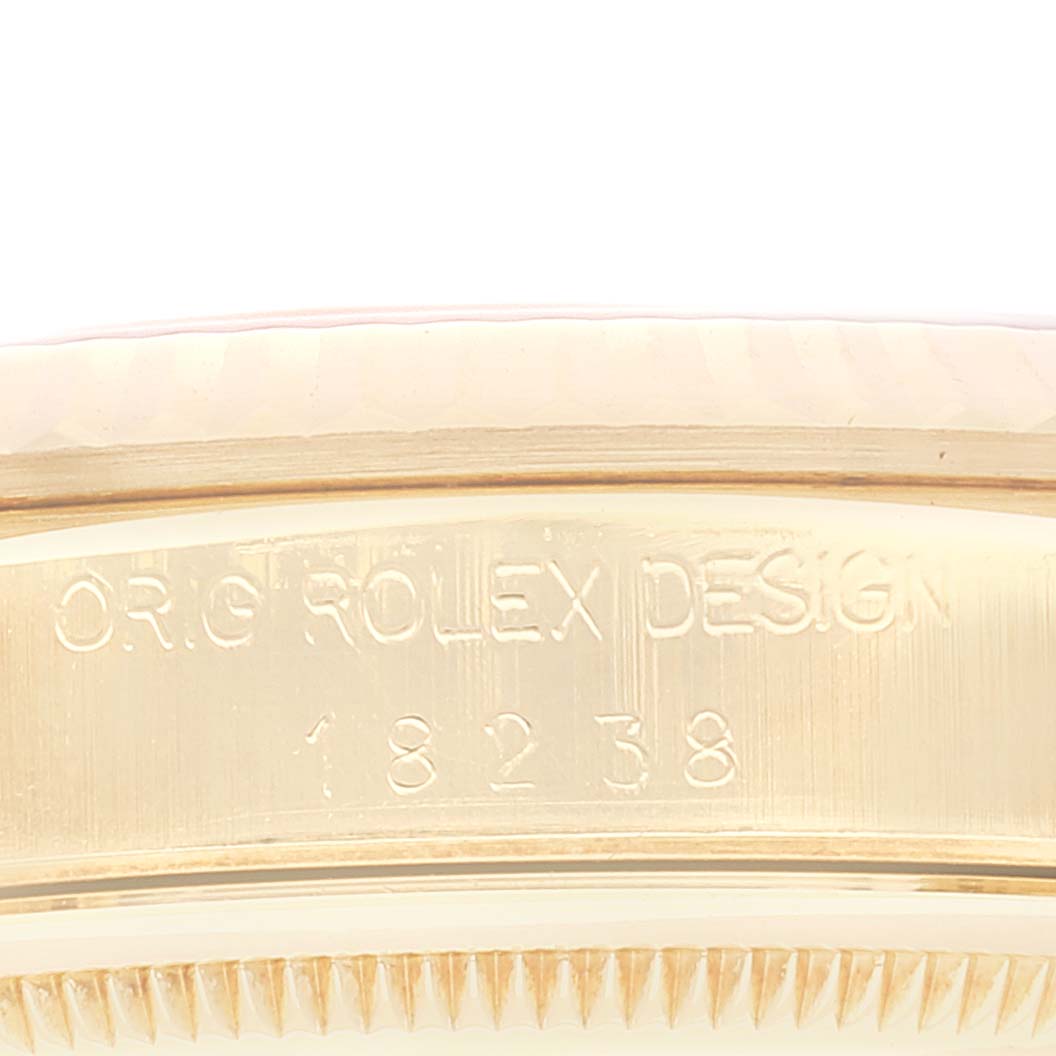 This close-up angle of the Rolex President 18238 Men
s Yellow Gold Champagne Dial 18238 Men
s Yellow Gold Champagne Dial model shows the engraved case back with the text "ORIG ROLEX DESIGN 18238."