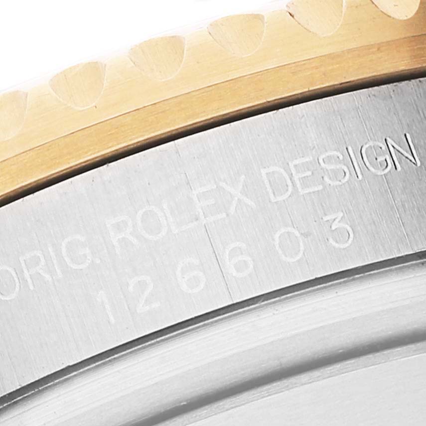 The image shows a close-up of the Sea-Dweller Rolex watch's bezel and engraved model number.