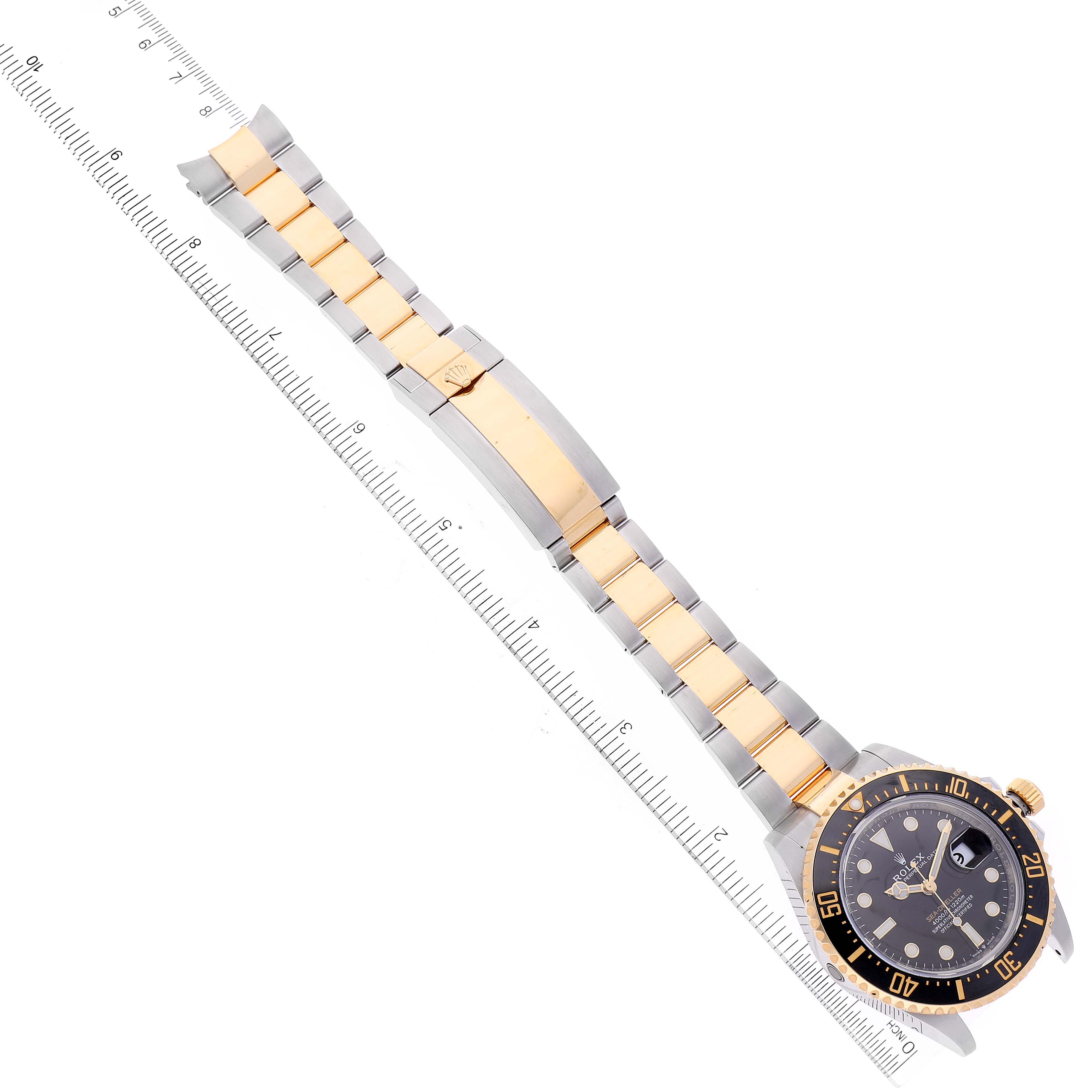 The image shows a Rolex Sea-Dweller 126603 Men's Steel and Gold (two tone) Black Dial 126603 Men's Steel and Gold (two tone) Black Dial watch laid flat with its face and entire band visible next to a measuring ruler.