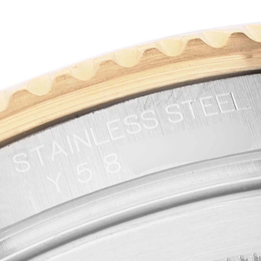 This image shows a close-up of the case back edge and part of the bezel of a Rolex Submariner 16613 Men's Steel and Gold (two tone) Blue Dial 16613 Men's Steel and Gold (two tone) Blue Dial watch, highlighting the "STAINLESS STEEL" engraving.