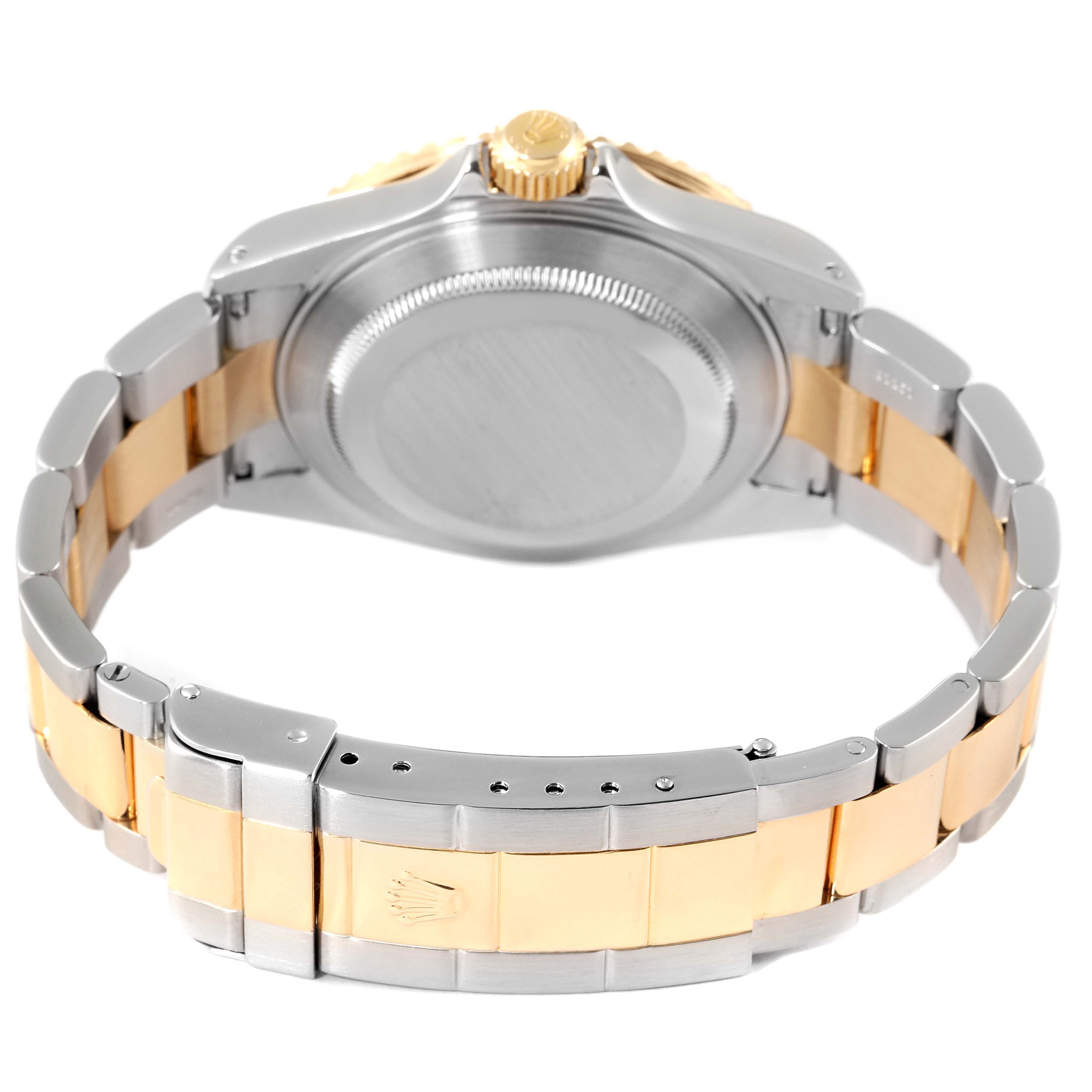 The image shows the back side of a Rolex Submariner 16613 Men's Steel and Gold (two tone) Blue Dial 16613 Men's Steel and Gold (two tone) Blue Dial, highlighting the bracelet, clasp, and back case.