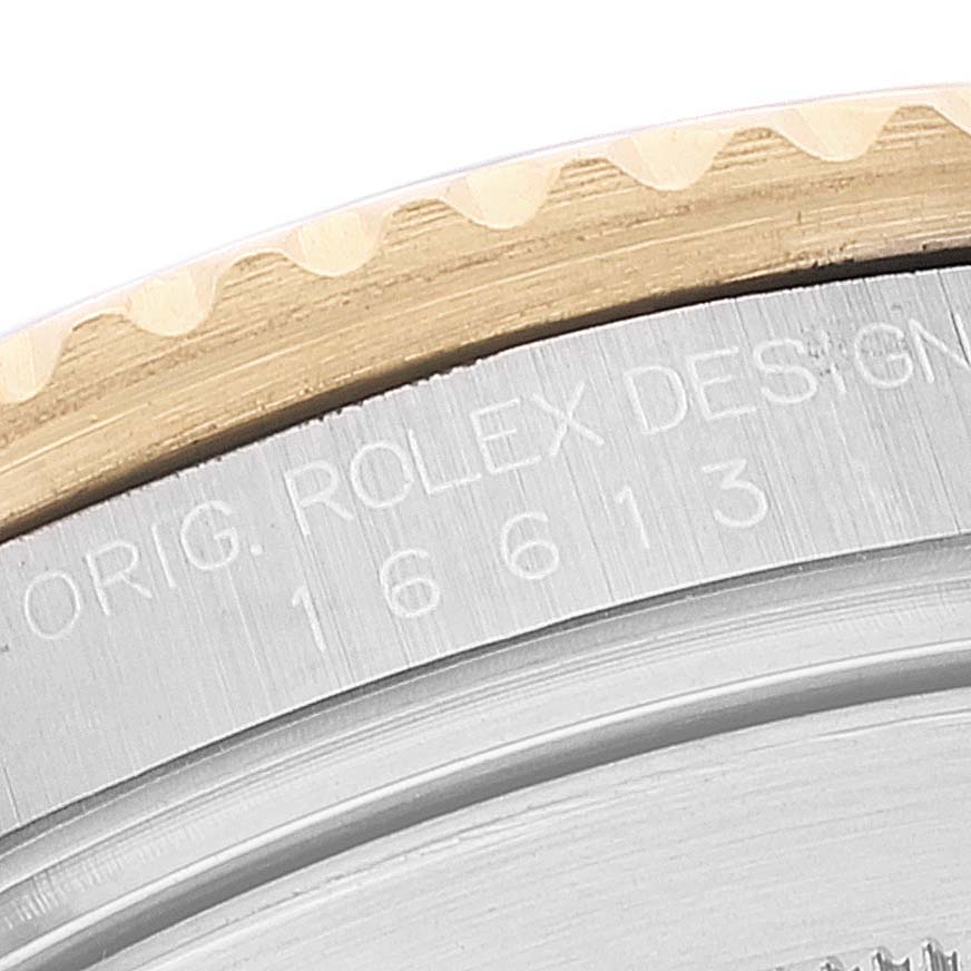 The image shows a close-up of the bezel and engraved text on the case back of a Rolex Submariner 16613 Men's Steel and Gold (two tone) Blue Dial 16613 Men's Steel and Gold (two tone) Blue Dial watch.