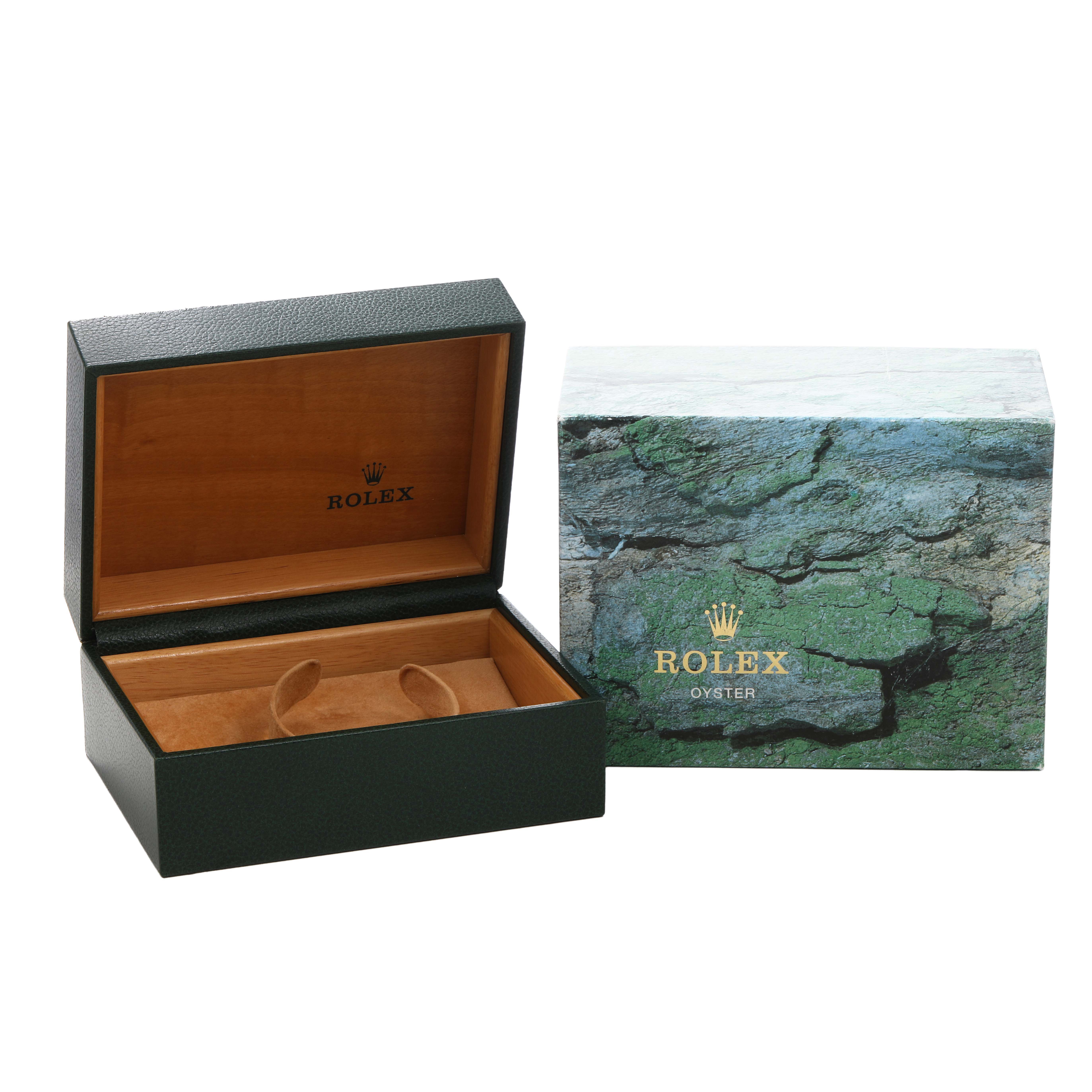 The image shows an open green Rolex box for a Submariner model, alongside its textured outer box.