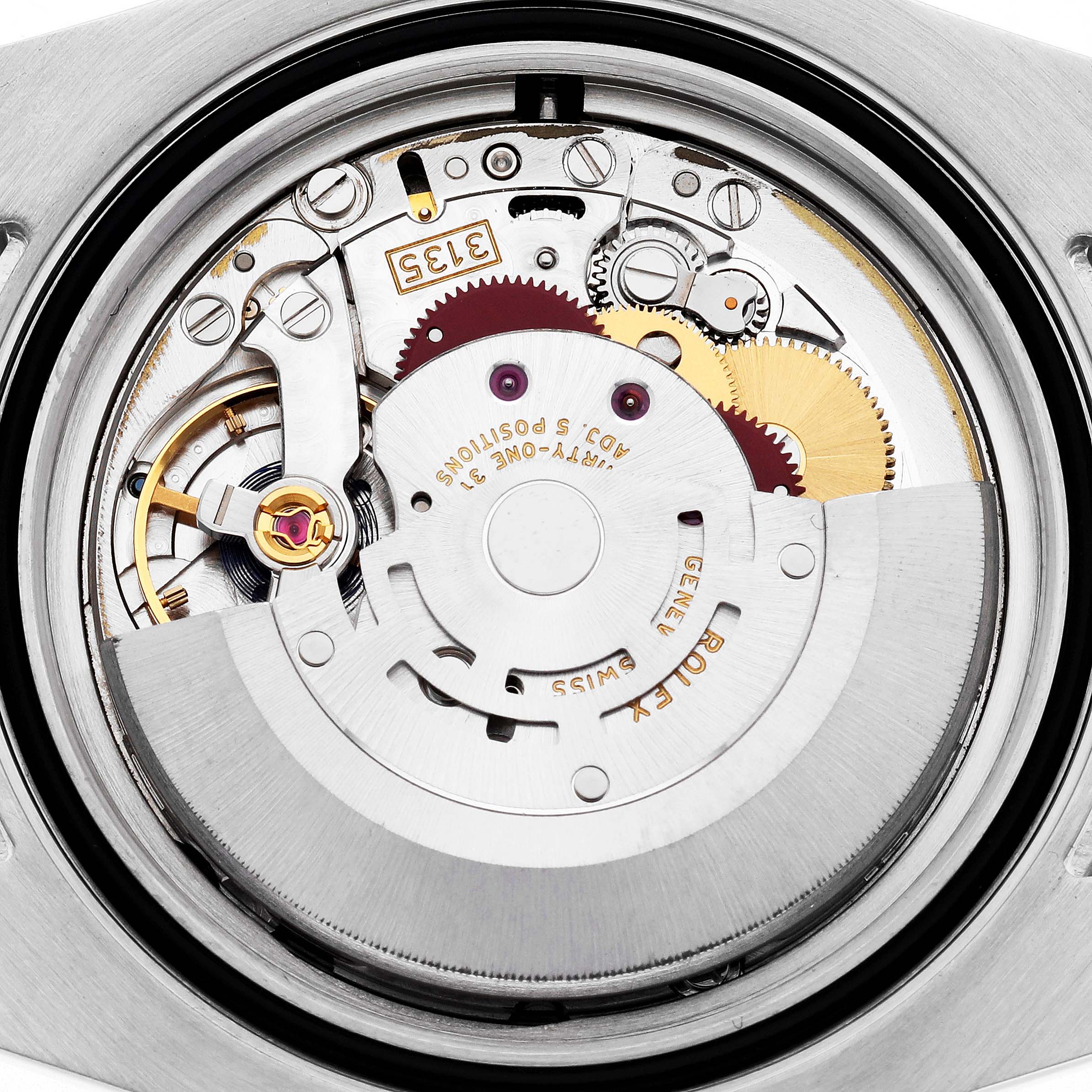 This image shows the internal mechanism of a Rolex Submariner 116613 Men
s Steel and Gold (two tone) Black Dial 116613 Men
s Steel and Gold (two tone) Black Dial watch from a top-down angle, highlighting the gears and rotor.