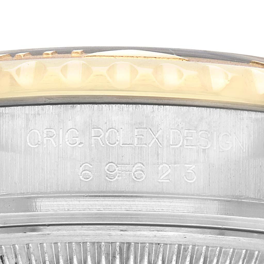 The image shows a close-up of the engraved side of a Rolex Yacht-Master 69623 Women
s Steel and Gold (two tone) White Dial 69623 Women
s Steel and Gold (two tone) White Dial bezel with part of the design number visible.