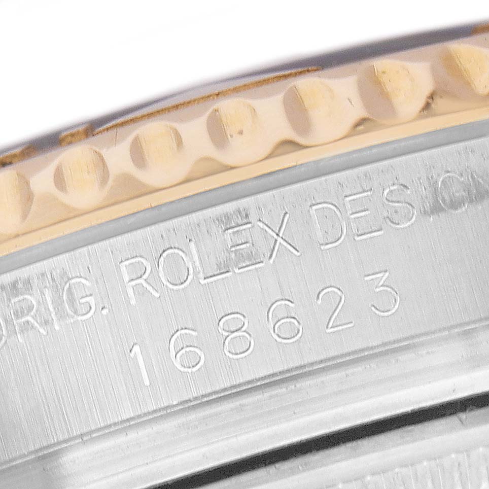 The image shows a close-up of the Rolex Yacht-Master 168623 Men's Steel and Gold (two tone) White Dial's side, highlighting the bezel edge and model number engraving.