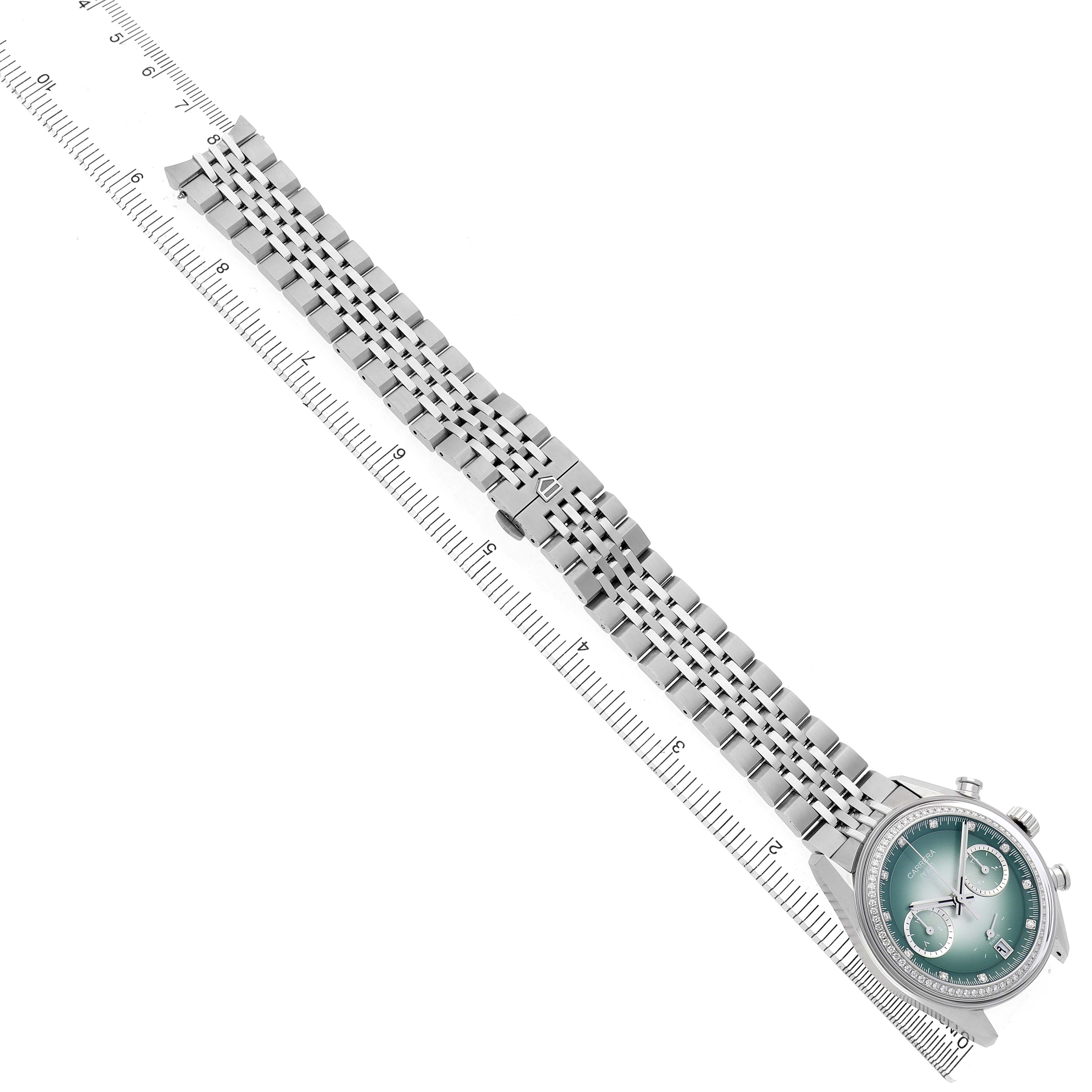 The Tag Heuer Carrera CBS221A Men's Stainless Steel Green Dial watch is shown from a top view, displaying the watch face and metal bracelet along a ruler.