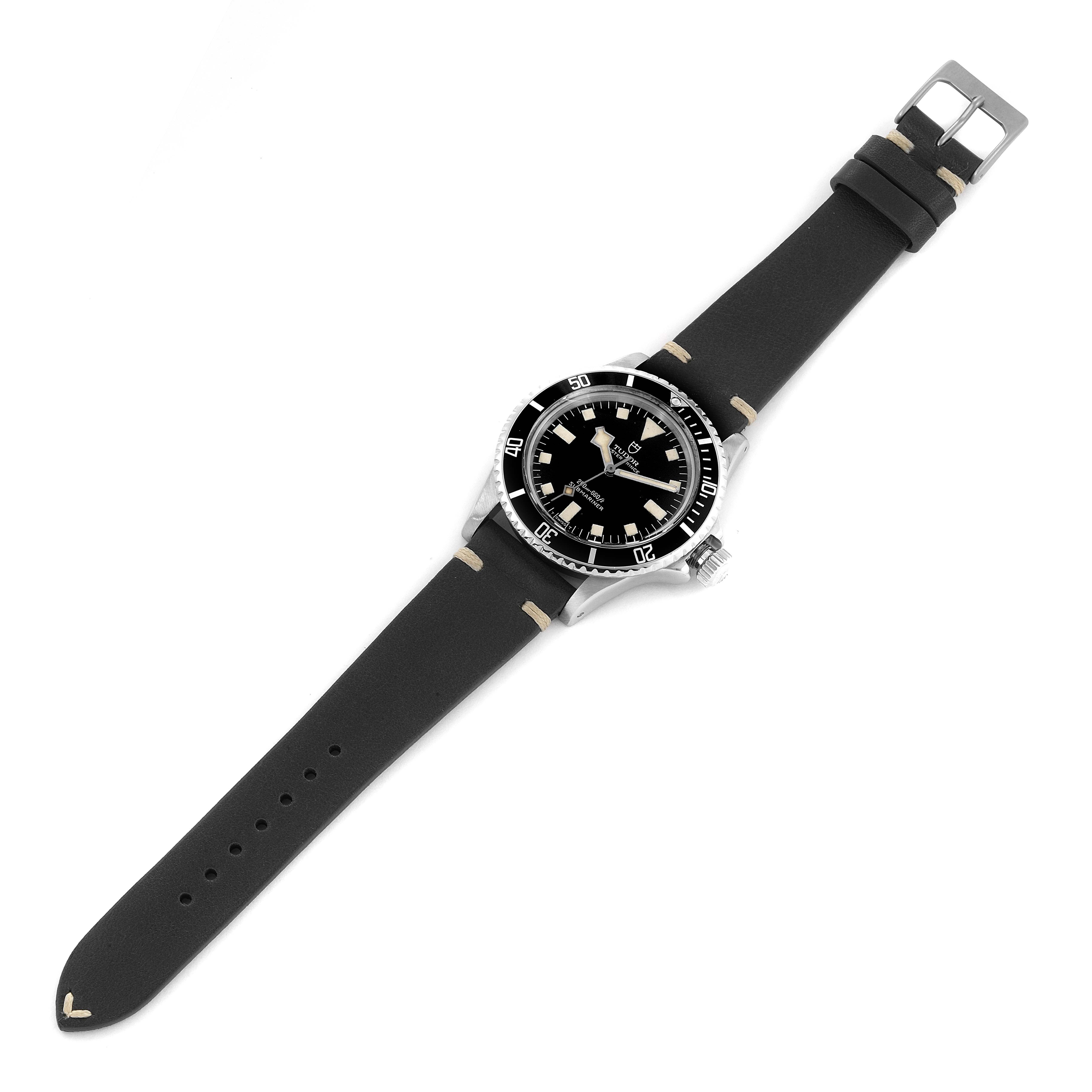 This image shows a Tudor Submariner 7016 Men
s Stainless Steel Black Dial 7016 Men
s Stainless Steel Black Dial watch viewed from a top-down angle on a black strap.