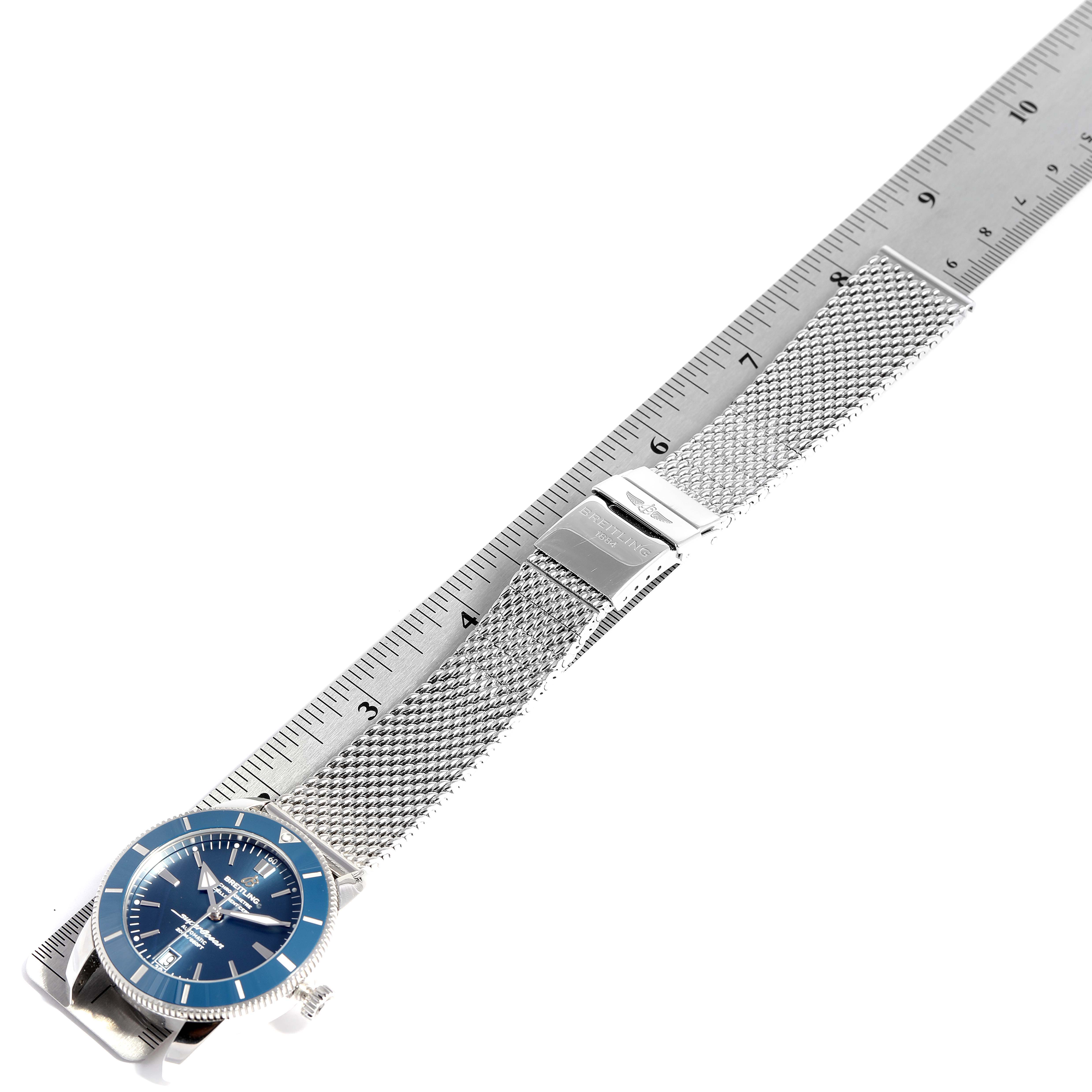 The image shows a Breitling Superocean AB2010161C1A1 Men's Stainless Steel Blue Dial AB2010161C1A1 Men's Stainless Steel Blue Dial watch laid flat next to a ruler, displaying its face, strap, and clasp from an angled top-down view.