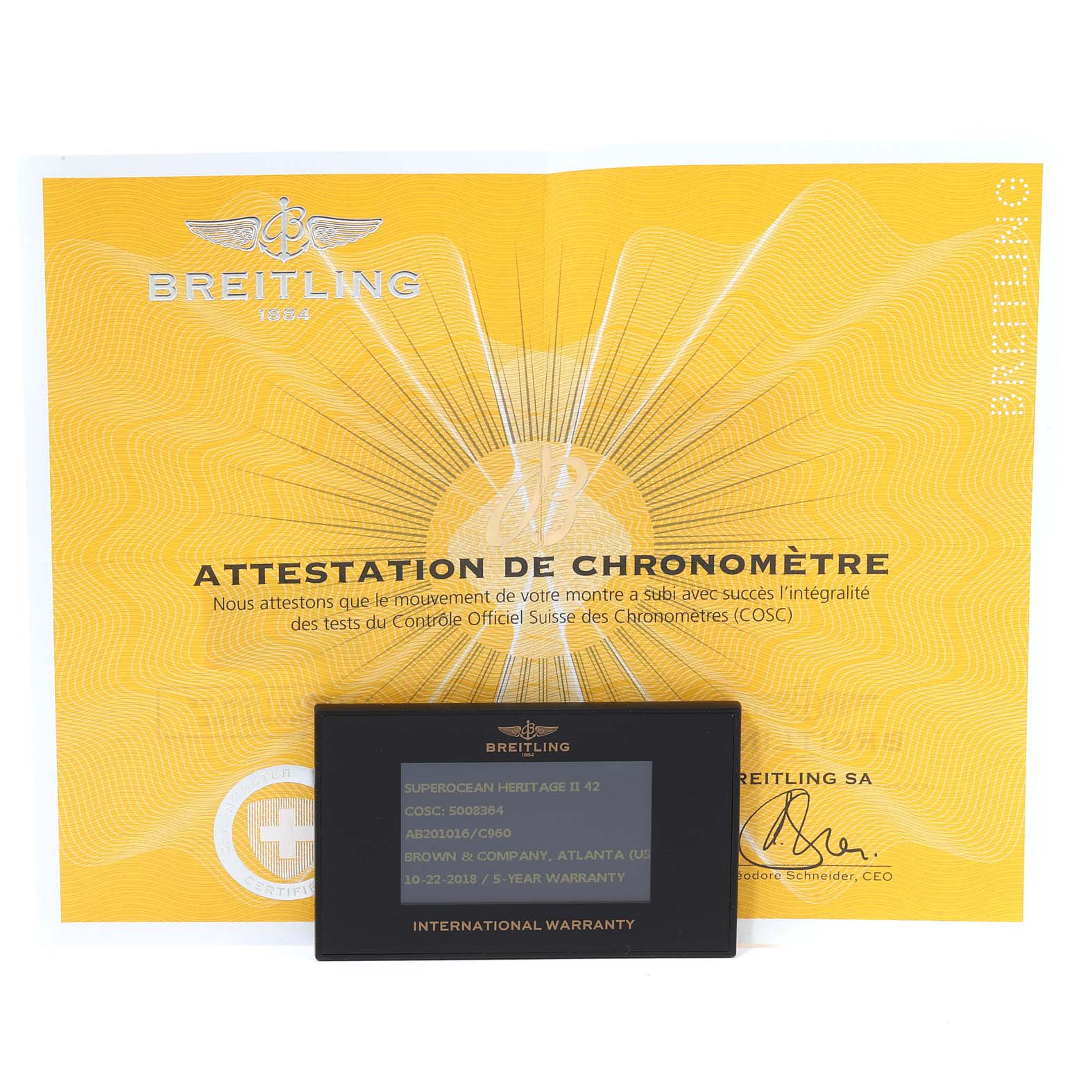 The image shows a yellow Breitling Superocean AB2010161C1A1 Men's Stainless Steel Blue Dial AB2010161C1A1 Men's Stainless Steel Blue Dial Attestation de Chronomètre and an international warranty card.
