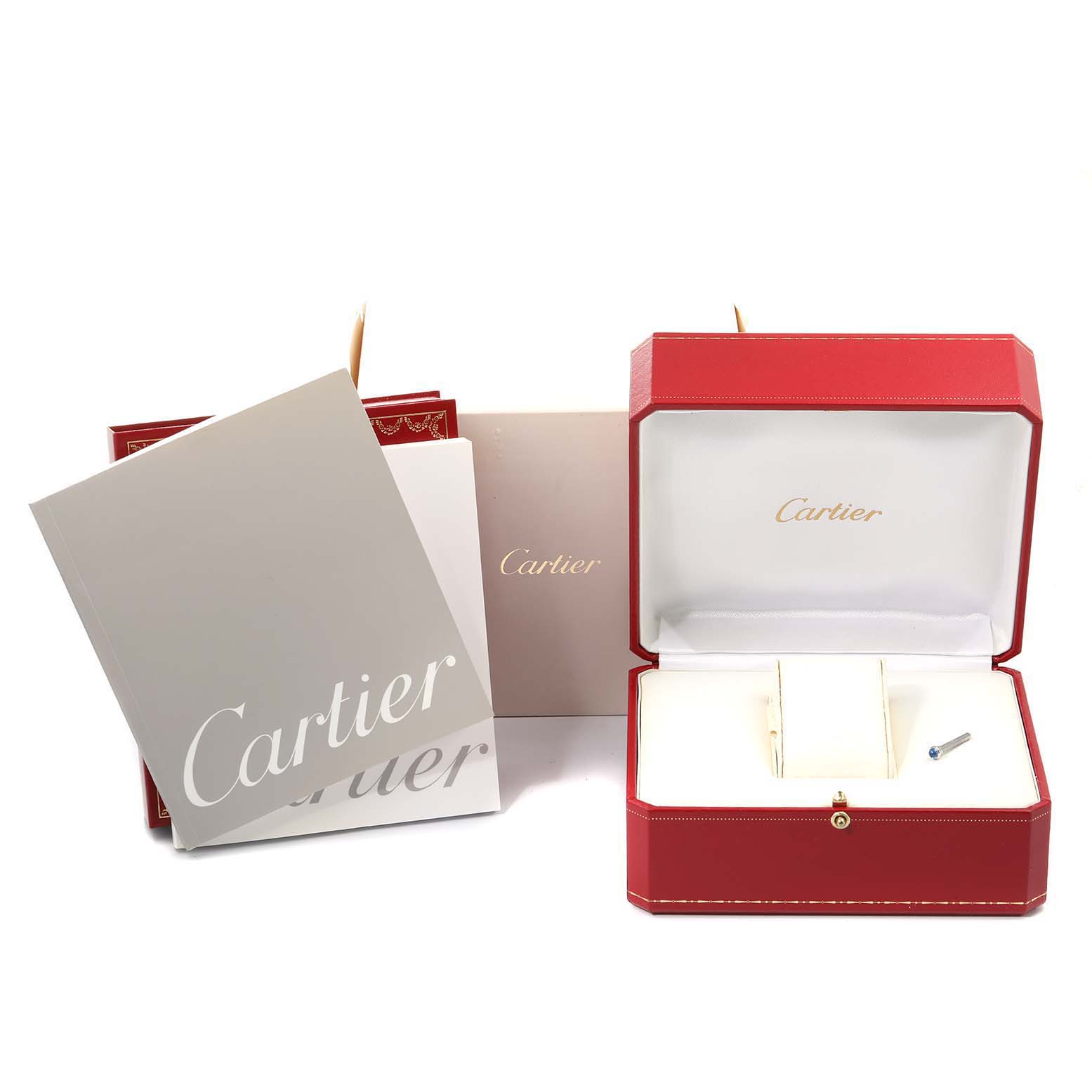 The image displays an empty red Cartier box for the Pasha model, accompanied by a manual and paperwork.