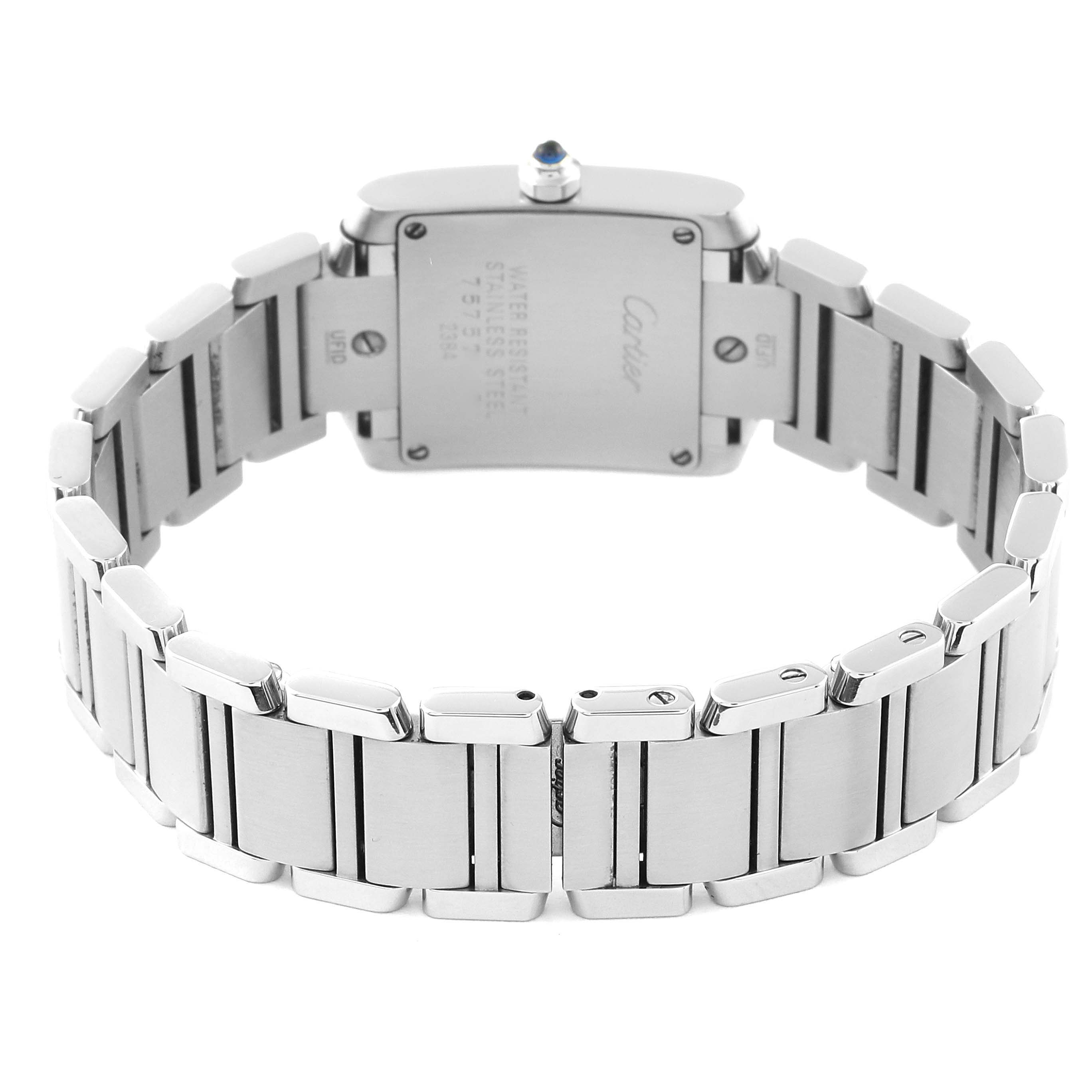 The image shows the back view of a Cartier Tank Française watch, highlighting the watch's case back and metal bracelet.