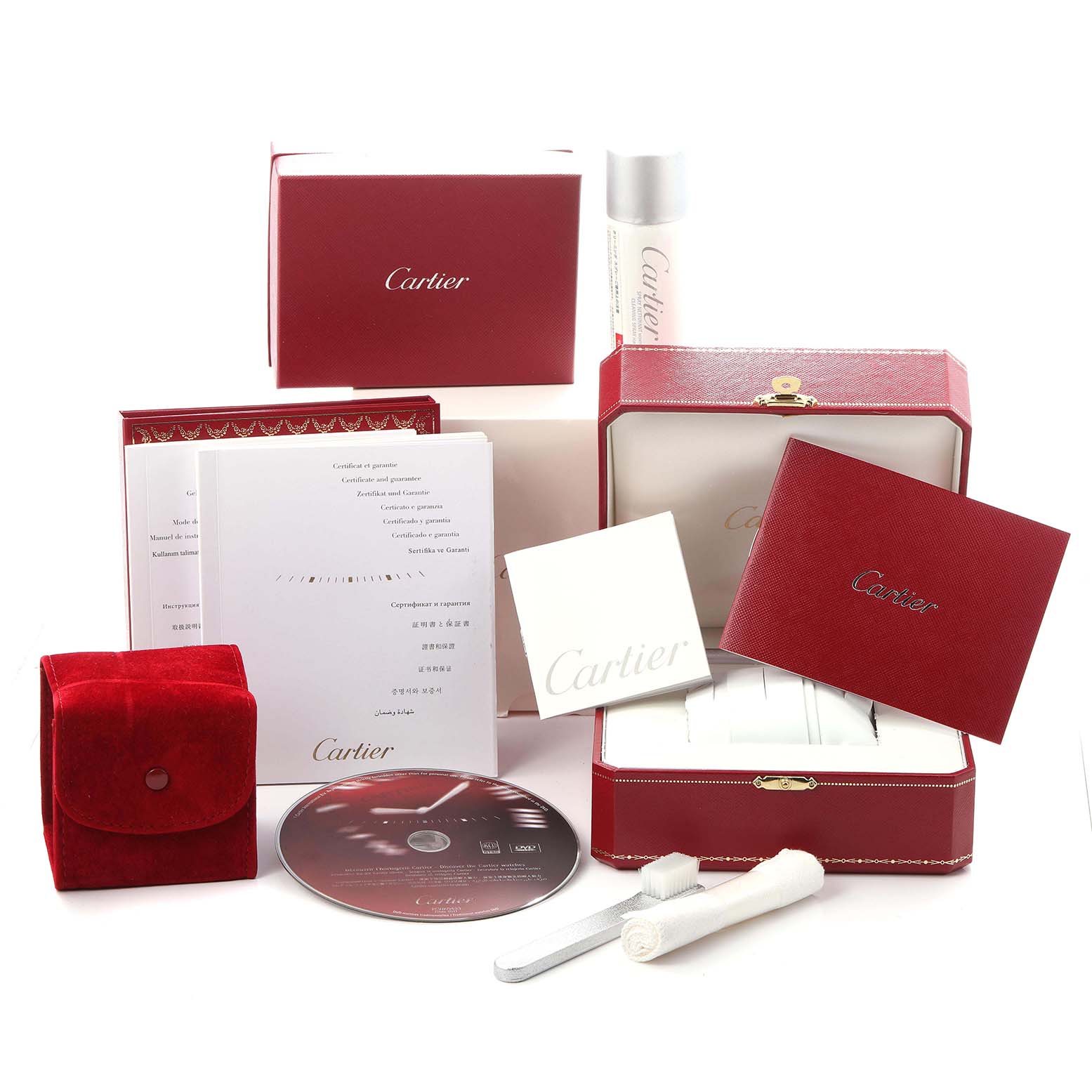The image shows accessories and packaging, including a box, manual, CD, and cleaning tools for the Cartier Tank Française watch.