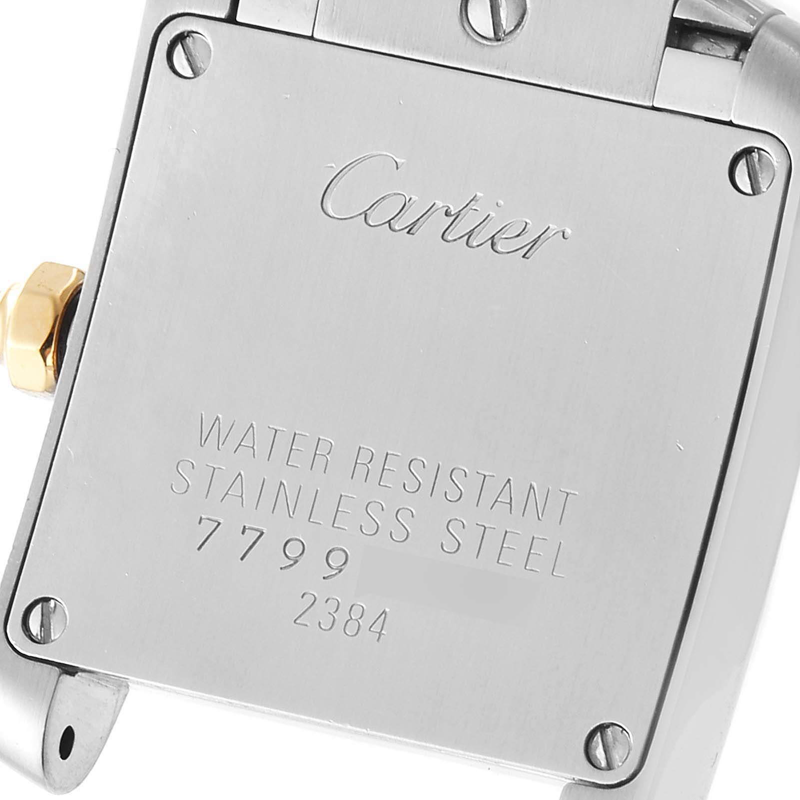 This is the back view of a Cartier Tank Francaise W51007Q4 Women's Steel and Gold (two tone) Silver Dial W51007Q4 Women's Steel and Gold (two tone) Silver Dial watch, showing the markings and screws.