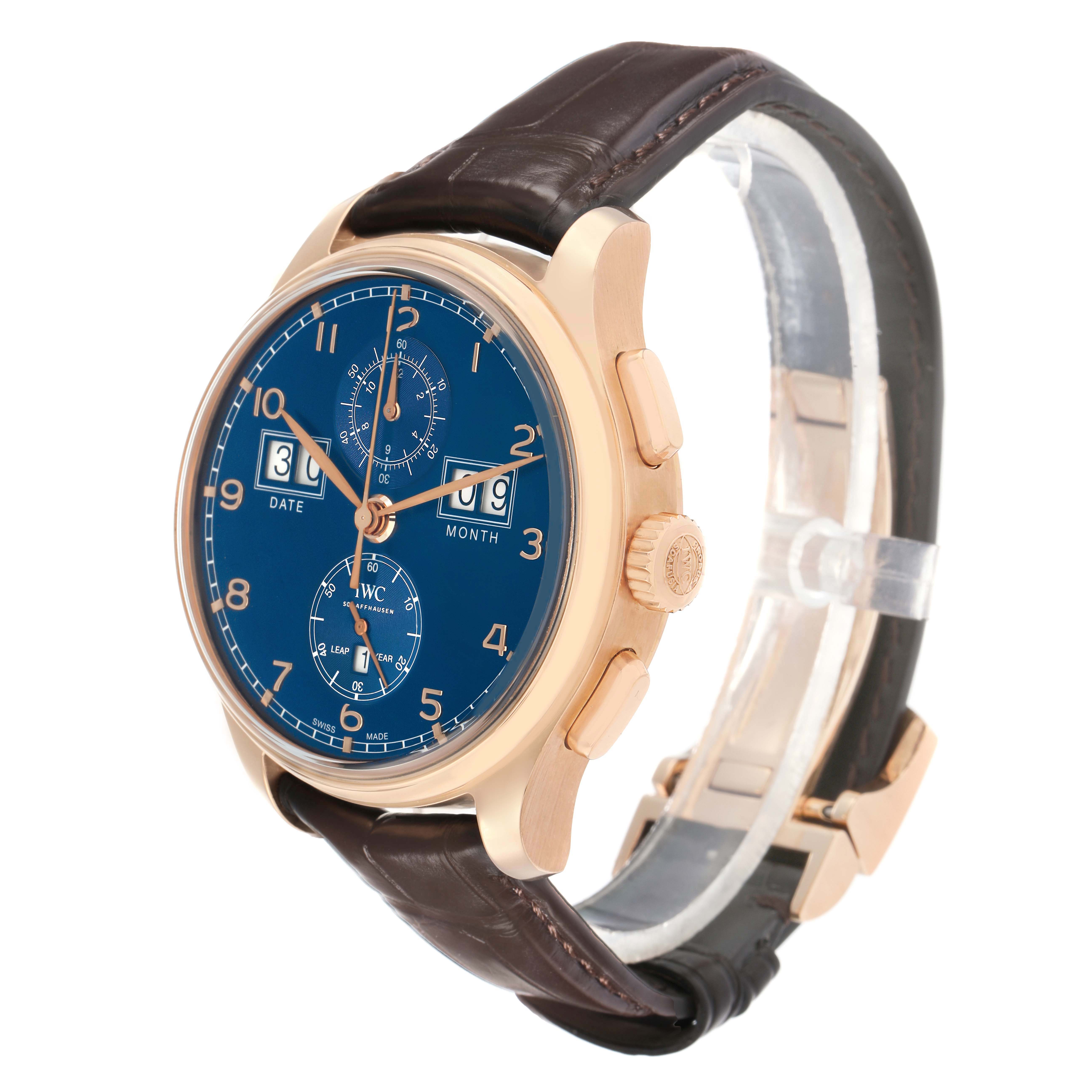 The IWC Portuguese IW397204 Men's Rose Gold Blue Dial watch is shown at a three-quarter angle, displaying the face, crown, and strap.
