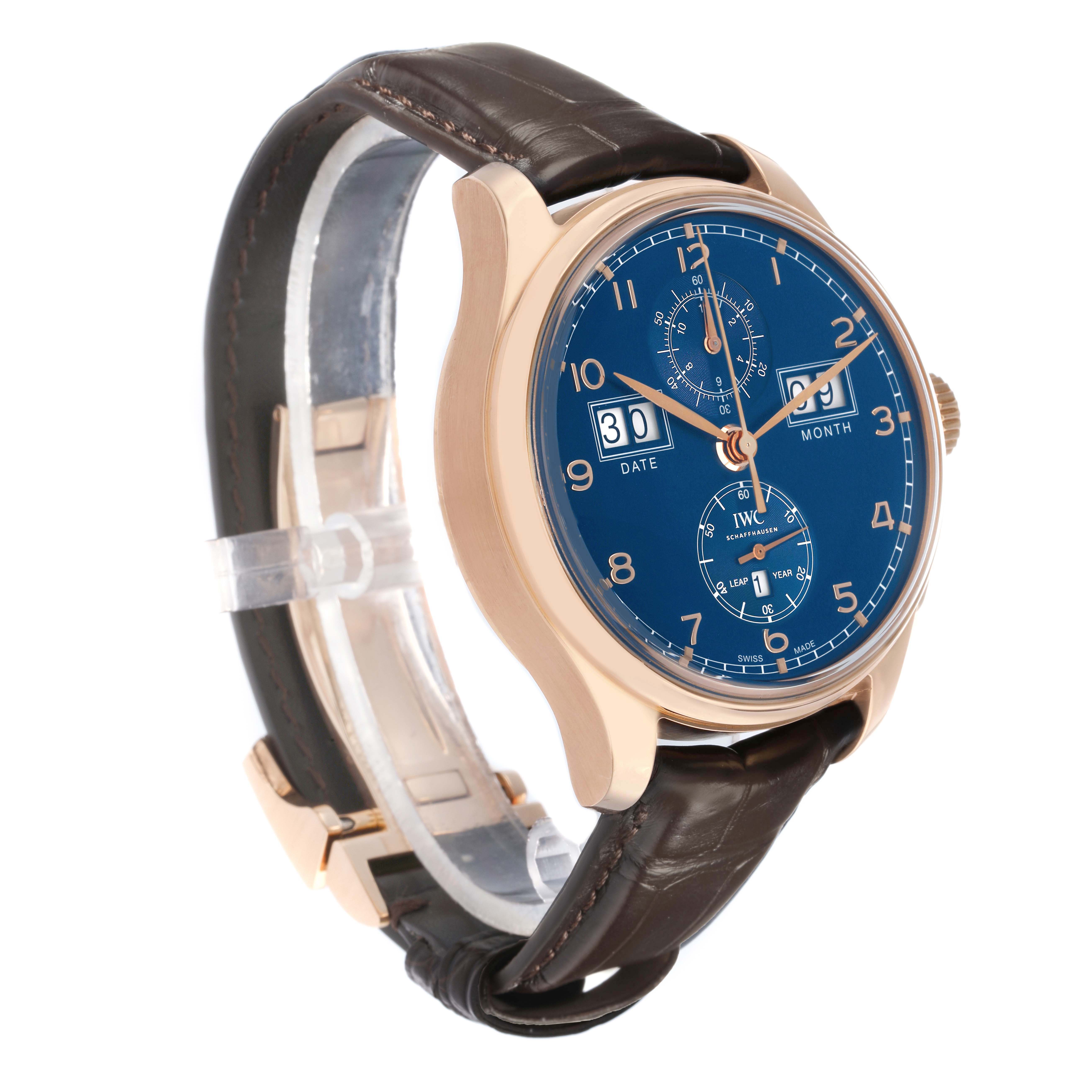 The IWC Portuguese IW397204 Men's Rose Gold Blue Dial watch is shown at a three-quarter angle, highlighting the blue dial, gold case, and leather strap.