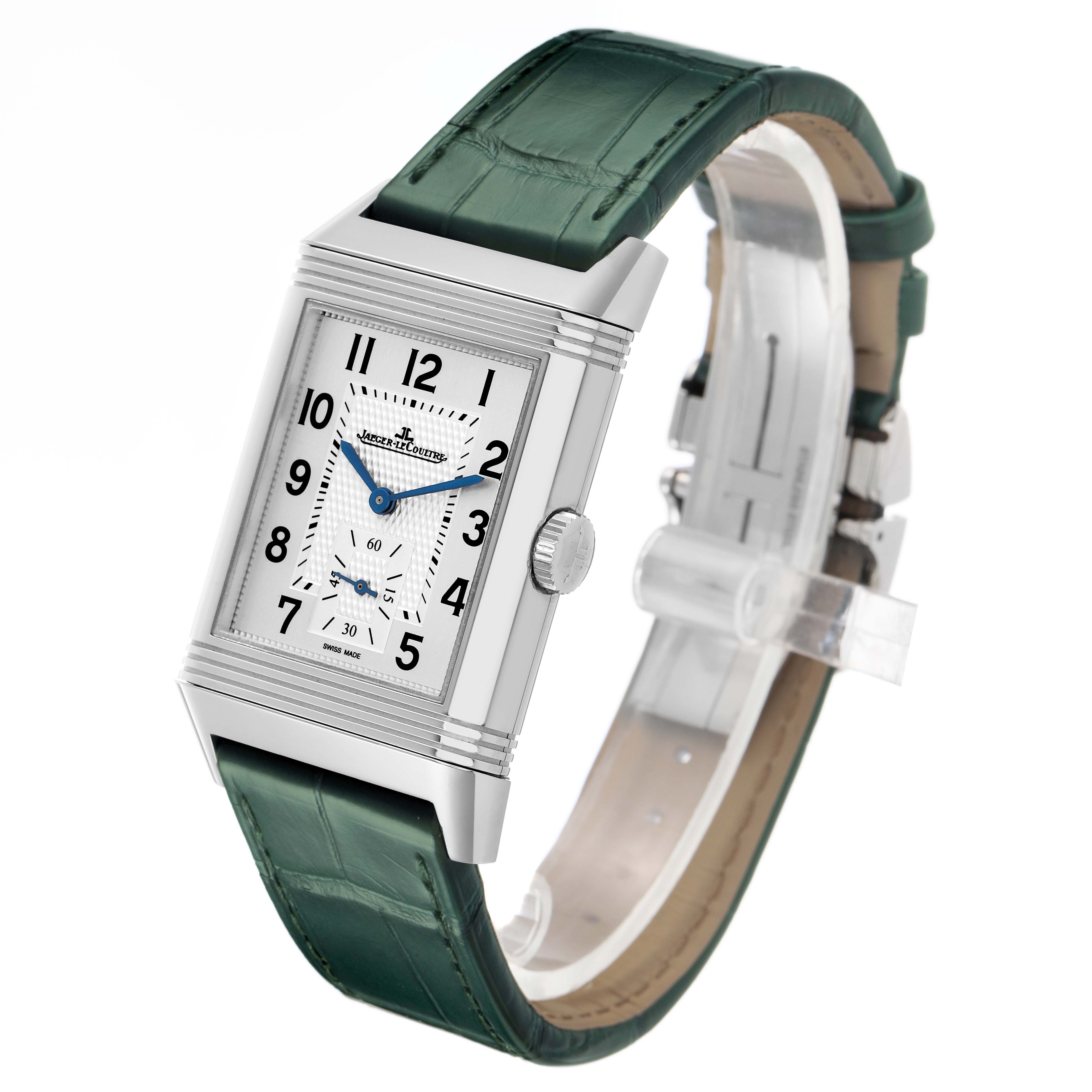 The Jaeger-LeCoultre Reverso watch is shown at a slight angle, highlighting the face, case, crown, and green leather strap.