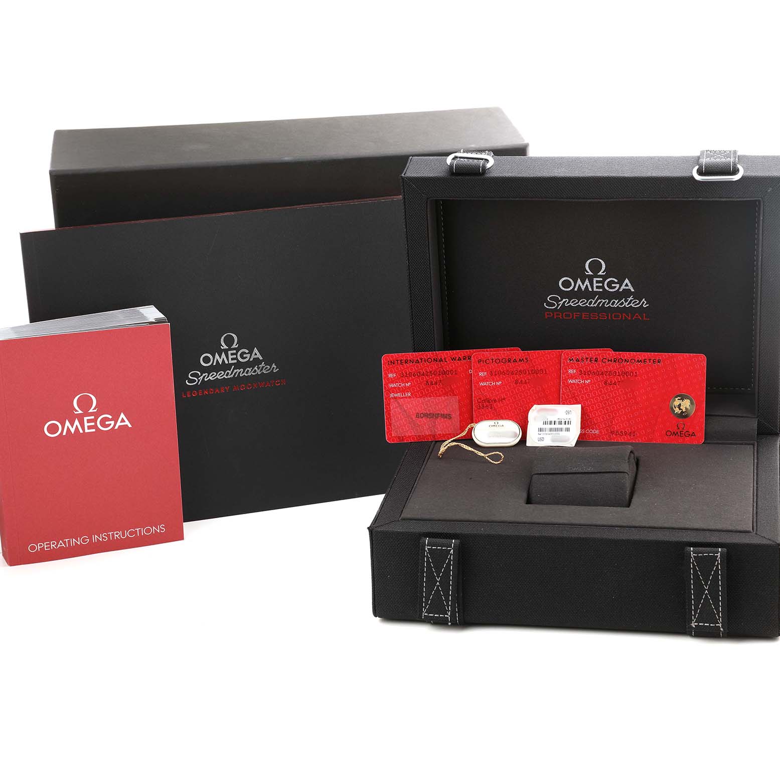 The Omega Speedmaster 310.60.42.50.10.001 Men's Yellow Gold Green Dial box is open, showing red cards, a manual, and a separate black cover, with no watch visible.