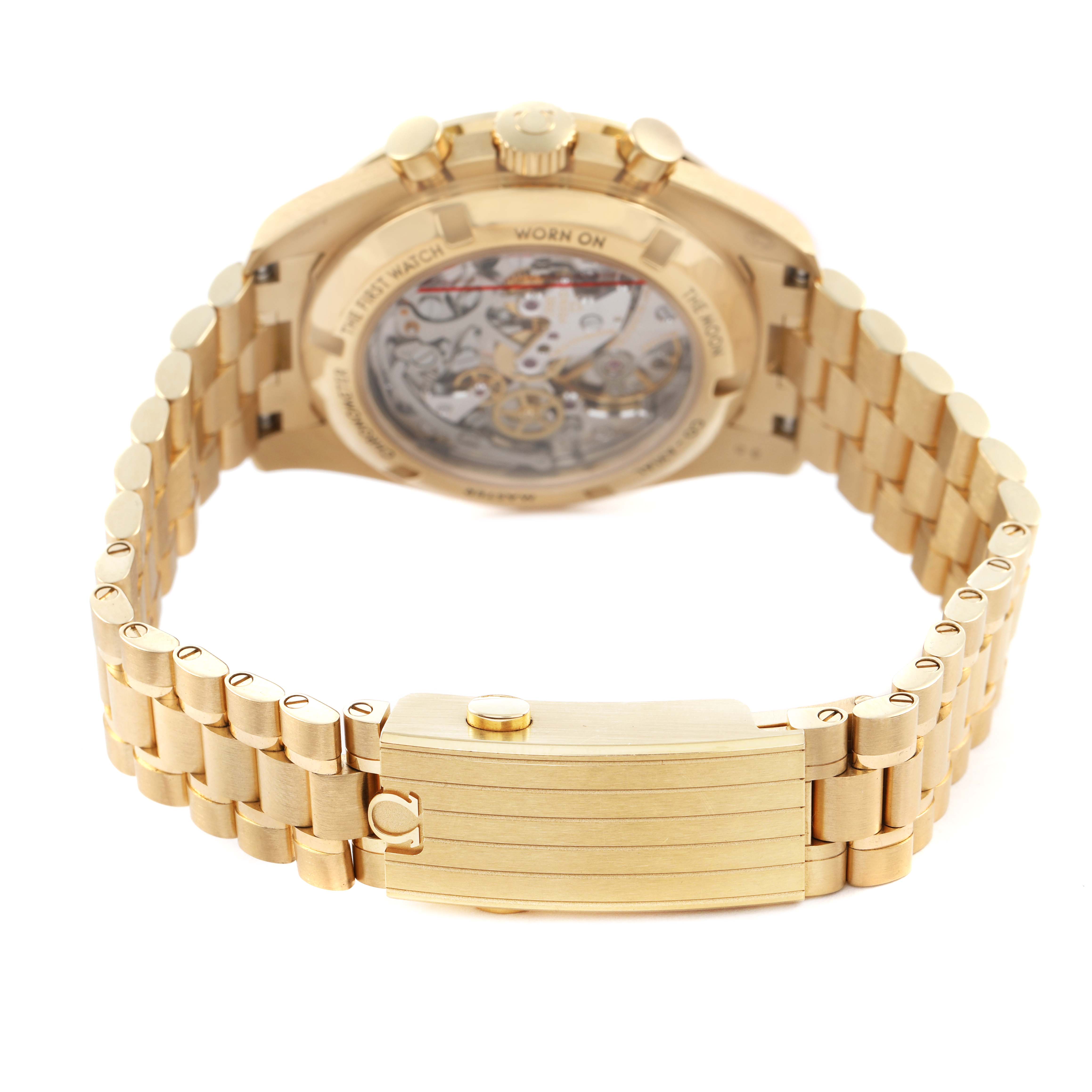 The Omega Speedmaster 310.60.42.50.10.001 Men's Yellow Gold Green Dial watch is shown from the rear, highlighting the transparent case back and gold bracelet with clasp.