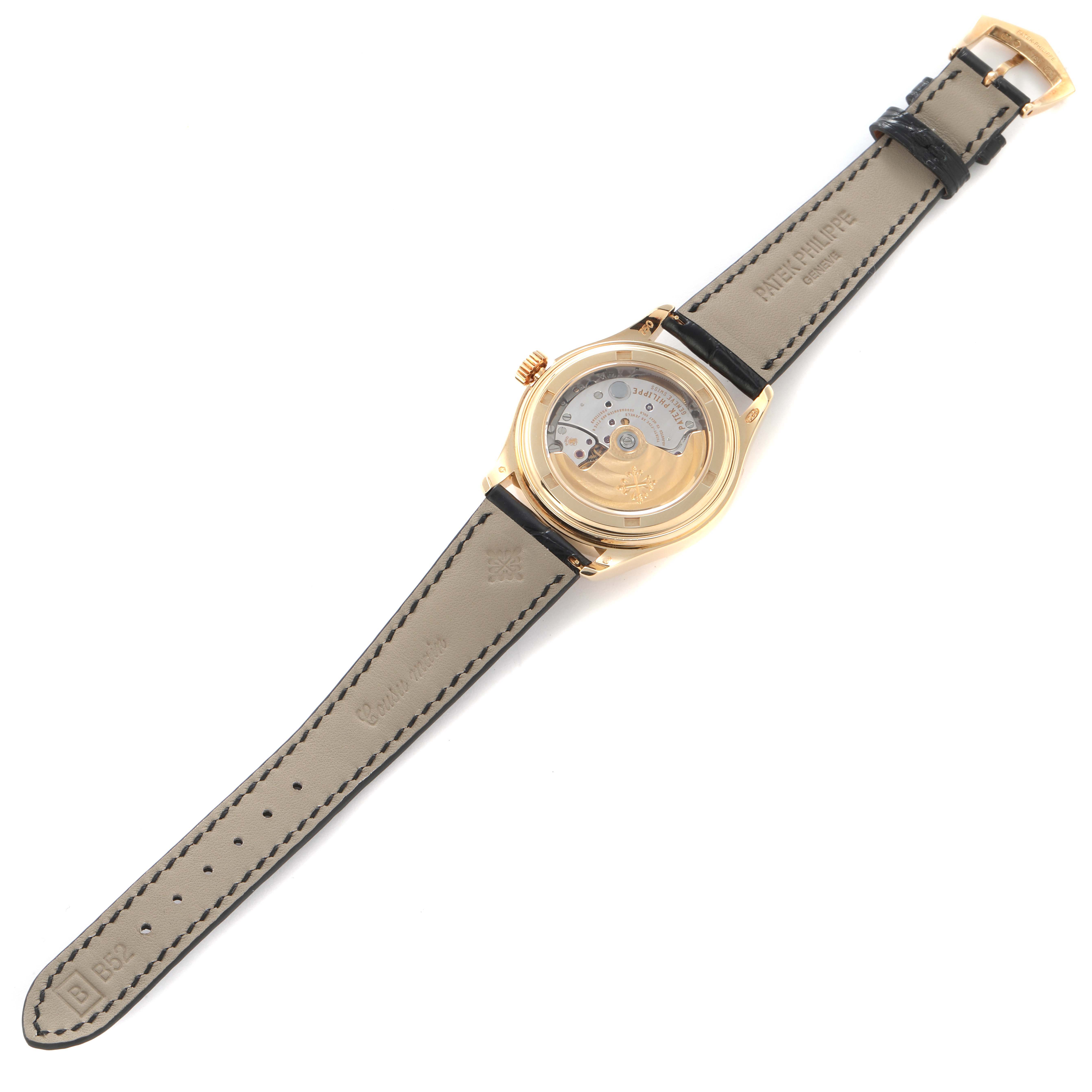 The Patek Philippe Complications 5035J-001 Men's Yellow Gold White Dial 5035J-001 Men's Yellow Gold White Dial watch is shown from the back, displaying the movement and leather strap.