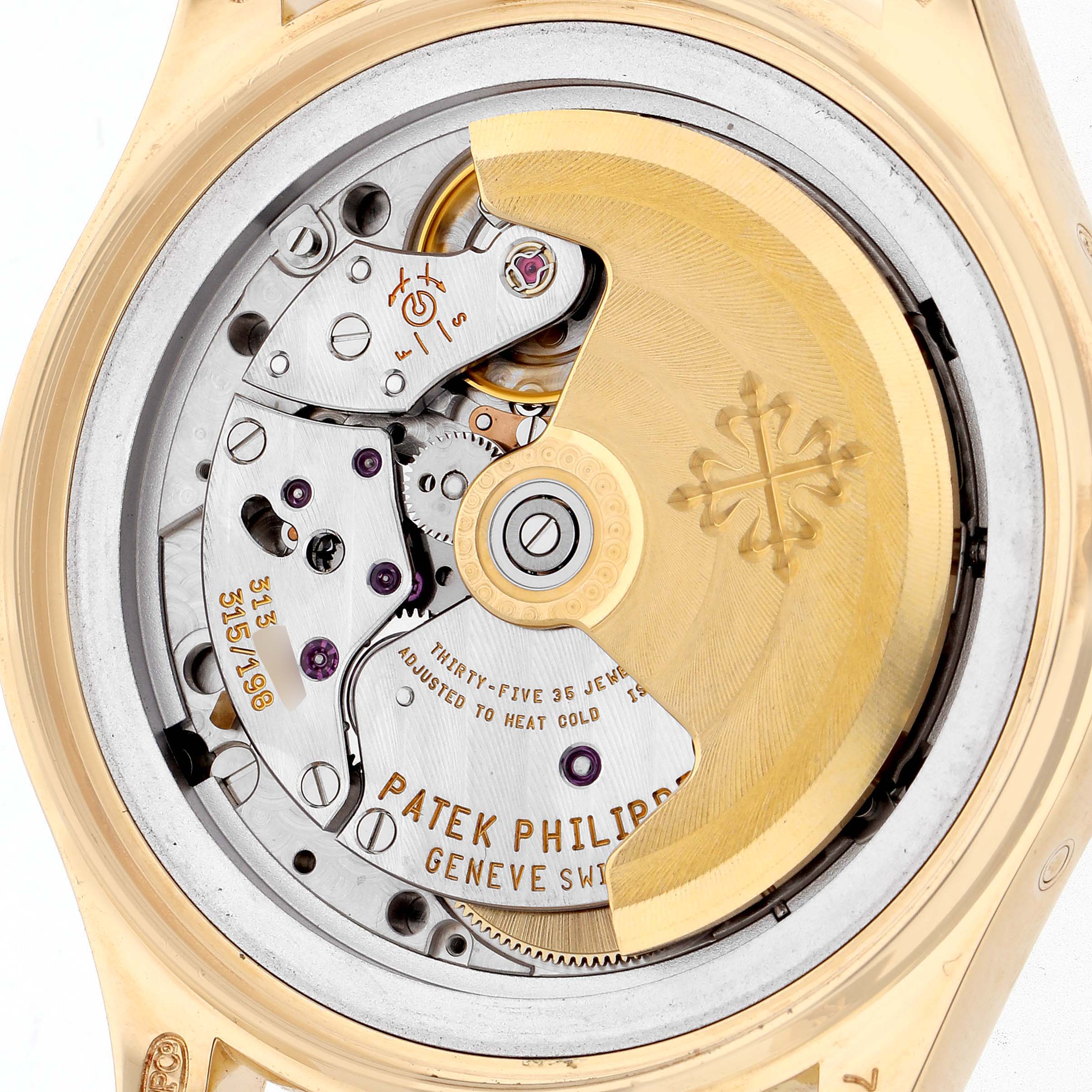 The image shows the intricate movement of the Patek Philippe Complications 5035J-001 Men's Yellow Gold White Dial 5035J-001 Men's Yellow Gold White Dial watch from a back view, highlighting the rotor and internal mechanics.