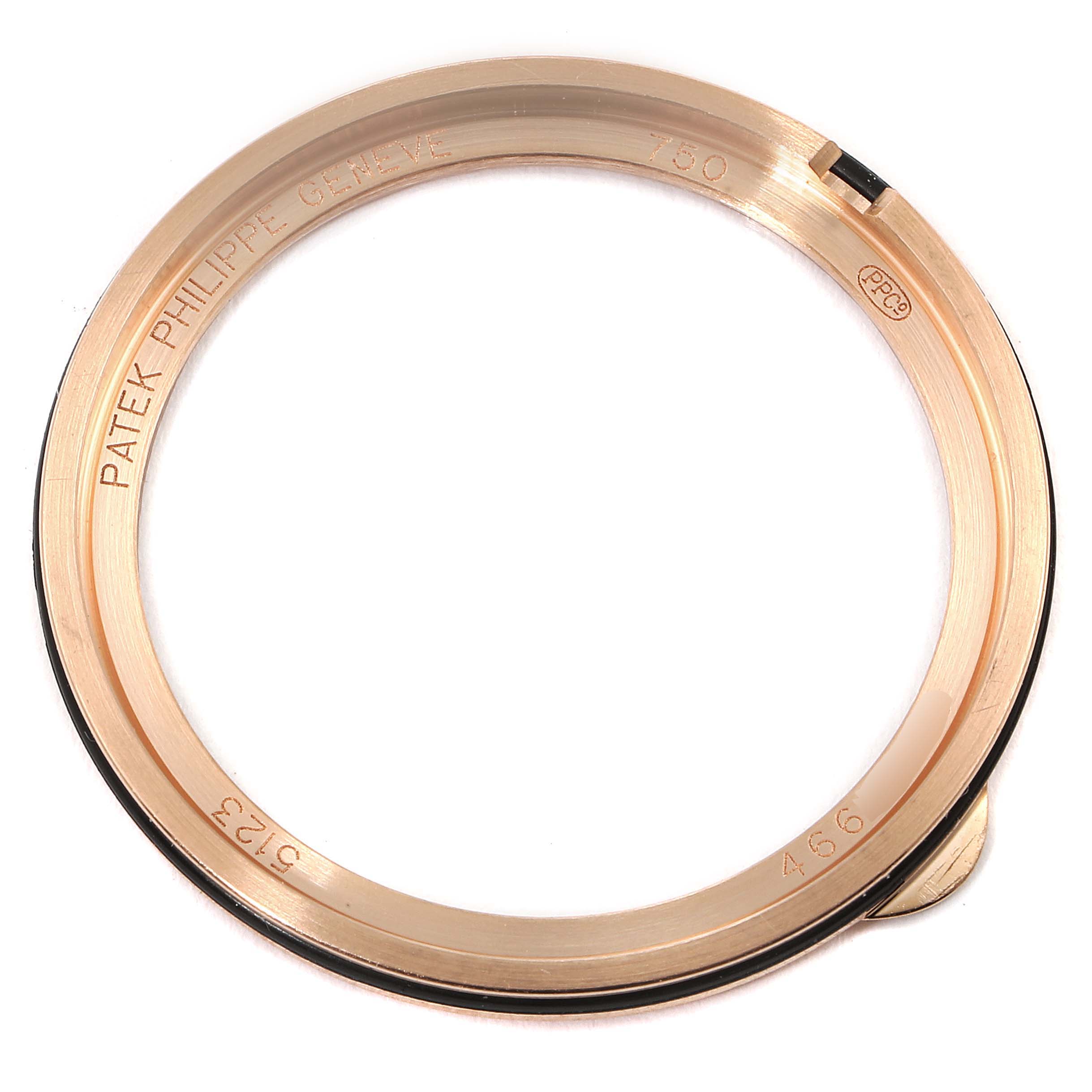 This is a close-up view of a watch bezel for the Patek Philippe Calatrava 5123R-001 Men's Rose Gold Silver Dial 5123R-001 Men's Rose Gold Silver Dial model, showing the engraved brand name and serial numbers.