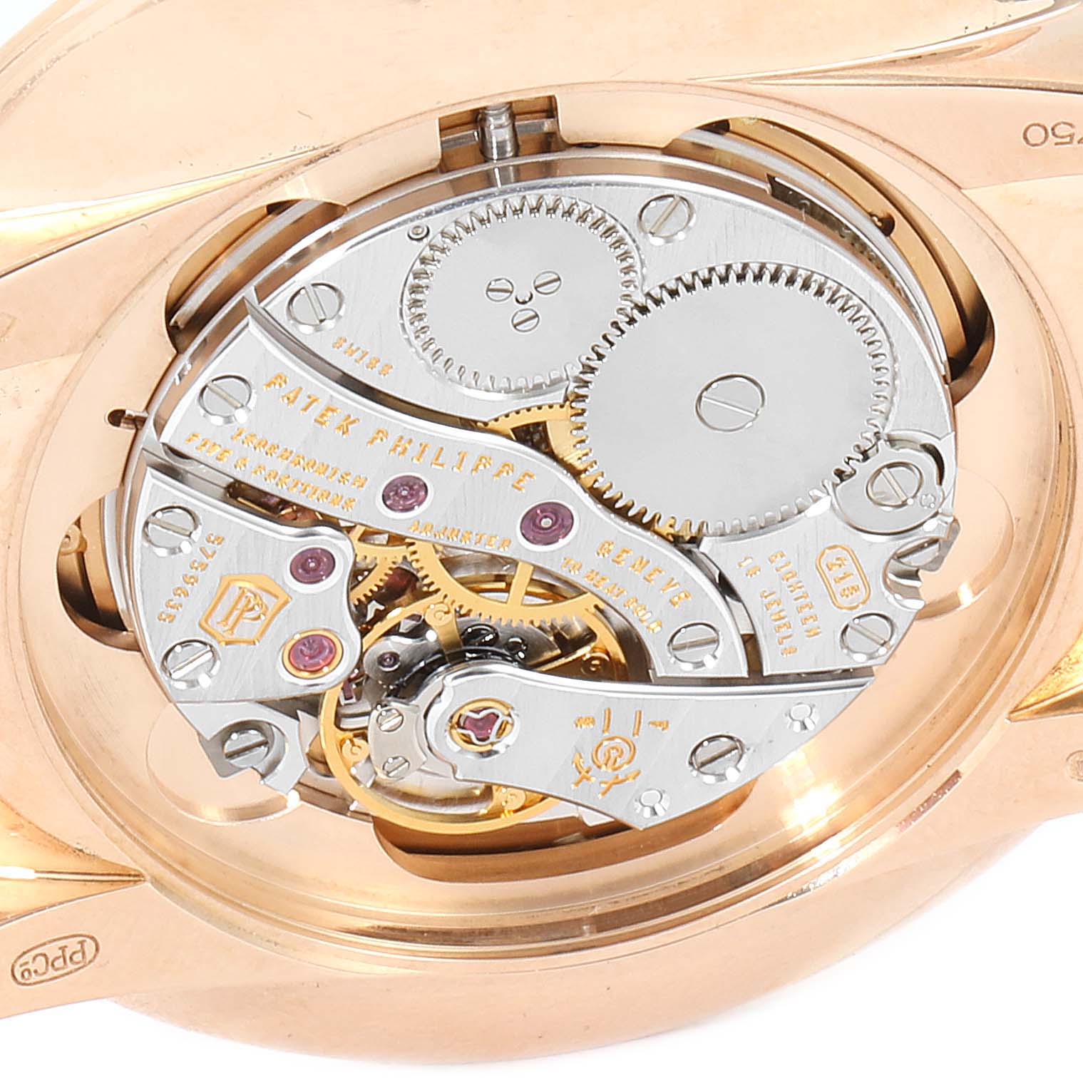 The image shows the intricate mechanical movement and the inner workings of the Calatrava model by Patek Philippe from the back.