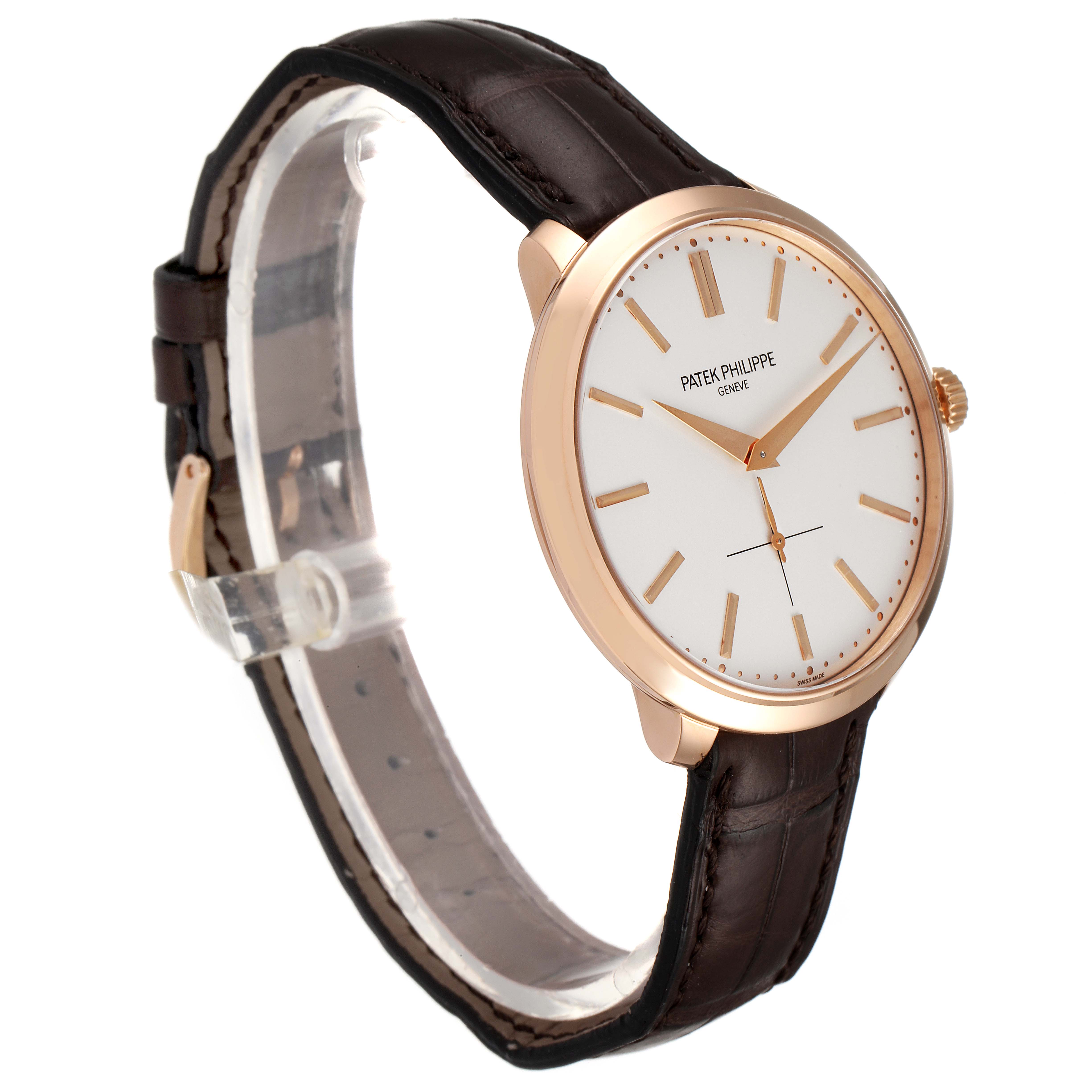 The image shows a side angle of the Patek Philippe Calatrava 5123R-001 Men's Rose Gold Silver Dial 5123R-001 Men's Rose Gold Silver Dial watch, highlighting its dial, case, crown, and leather strap.