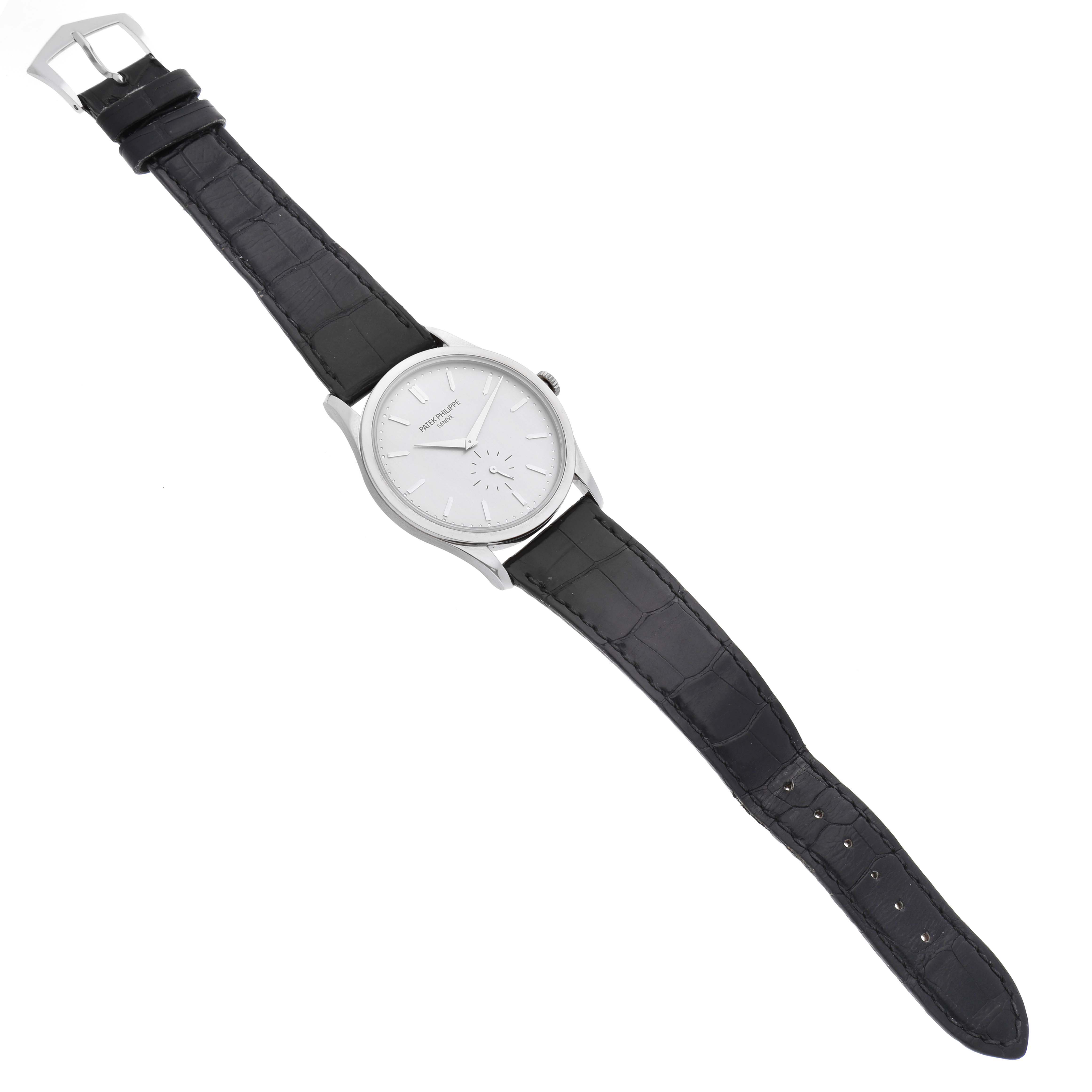 The image shows a Patek Philippe Calatrava 5196G Men
s White Gold Silver Dial 5196G Men
s White Gold Silver Dial watch from a top-down angle, displaying the full watch with its dial and leather strap.