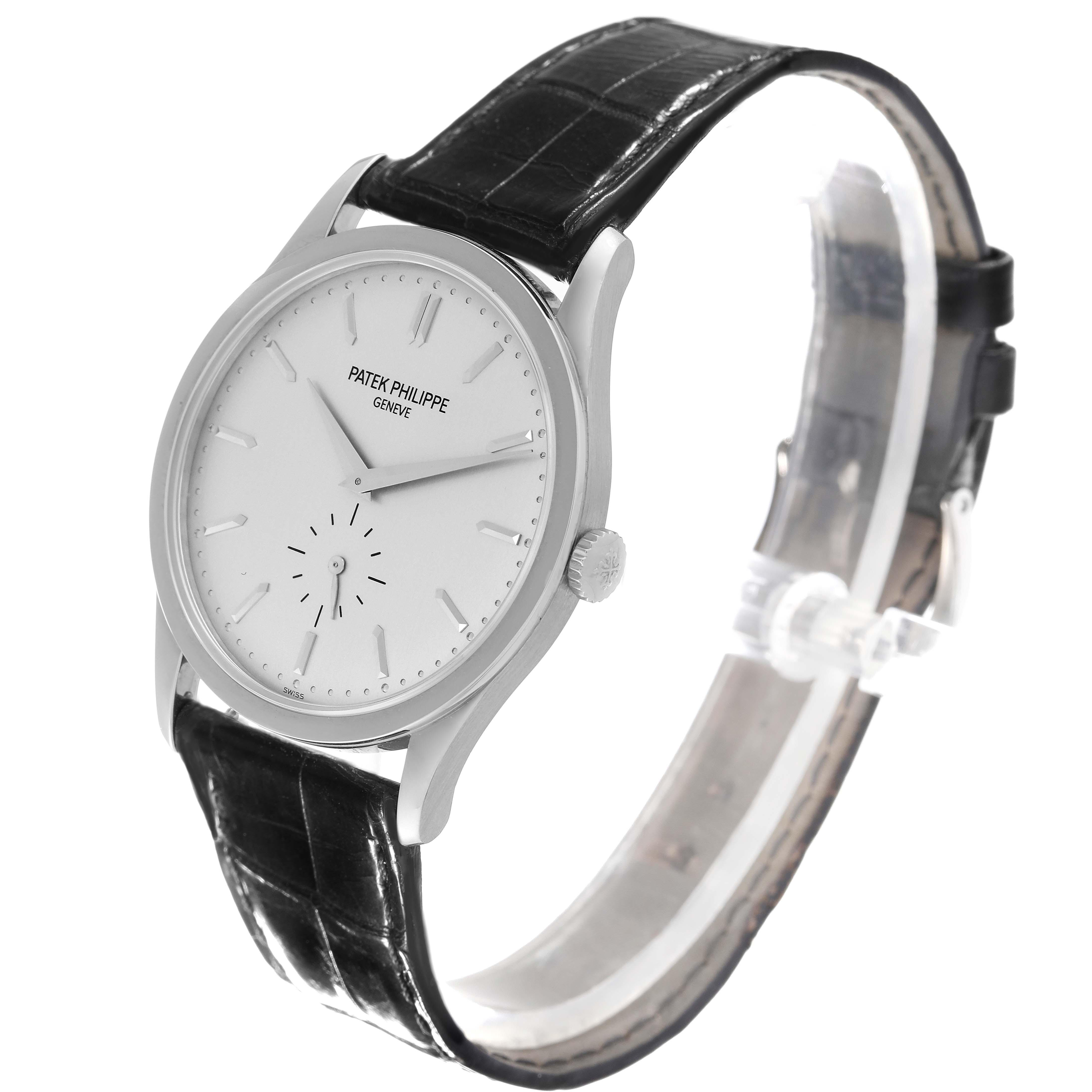 The image shows a side angle view of a Patek Philippe Calatrava 5196G Men
s White Gold Silver Dial 5196G Men
s White Gold Silver Dial watch with a black leather strap and a white dial.