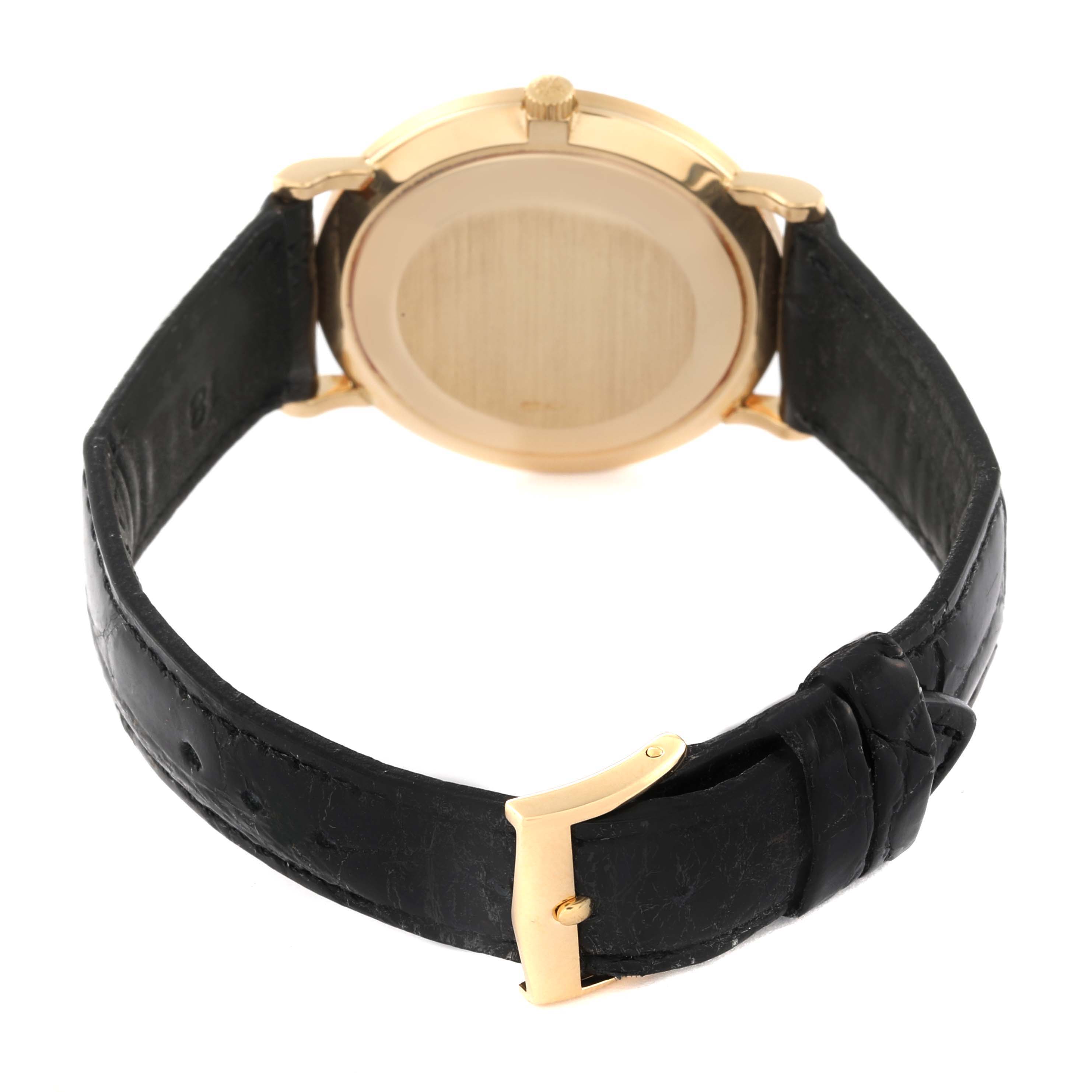 This image shows the back view of the Patek Philippe Calatrava 3919J Men's Yellow Gold White Dial 3919J Men's Yellow Gold White Dial watch, focusing on the case back, strap, and buckle.