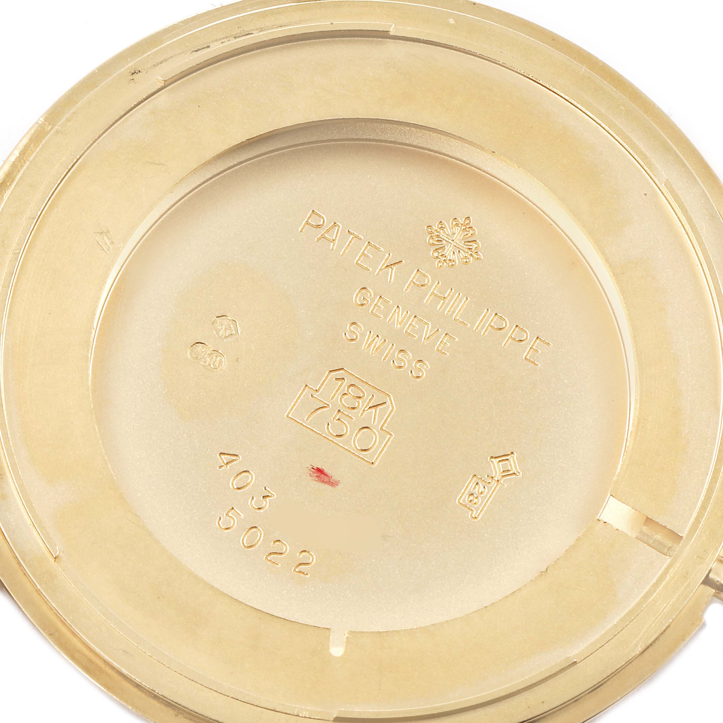 The image shows the case back of a Patek Philippe Calatrava 5022 Men's Yellow Gold White Dial 5022 Men's Yellow Gold White Dial model, displaying inscriptions and markings in gold.