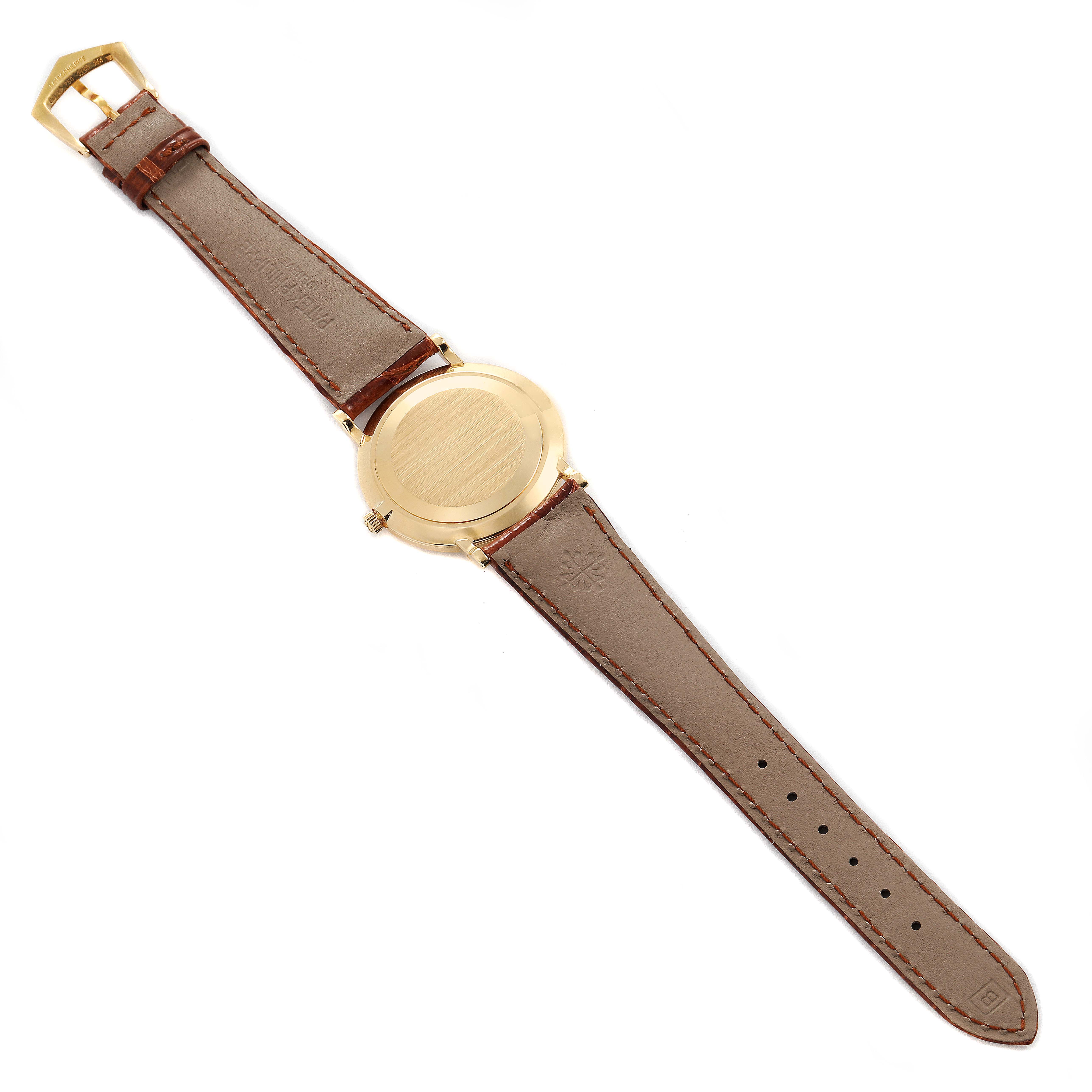 The image shows the back view of the Calatrava model by Patek Philippe, highlighting the leather strap and closed case back.