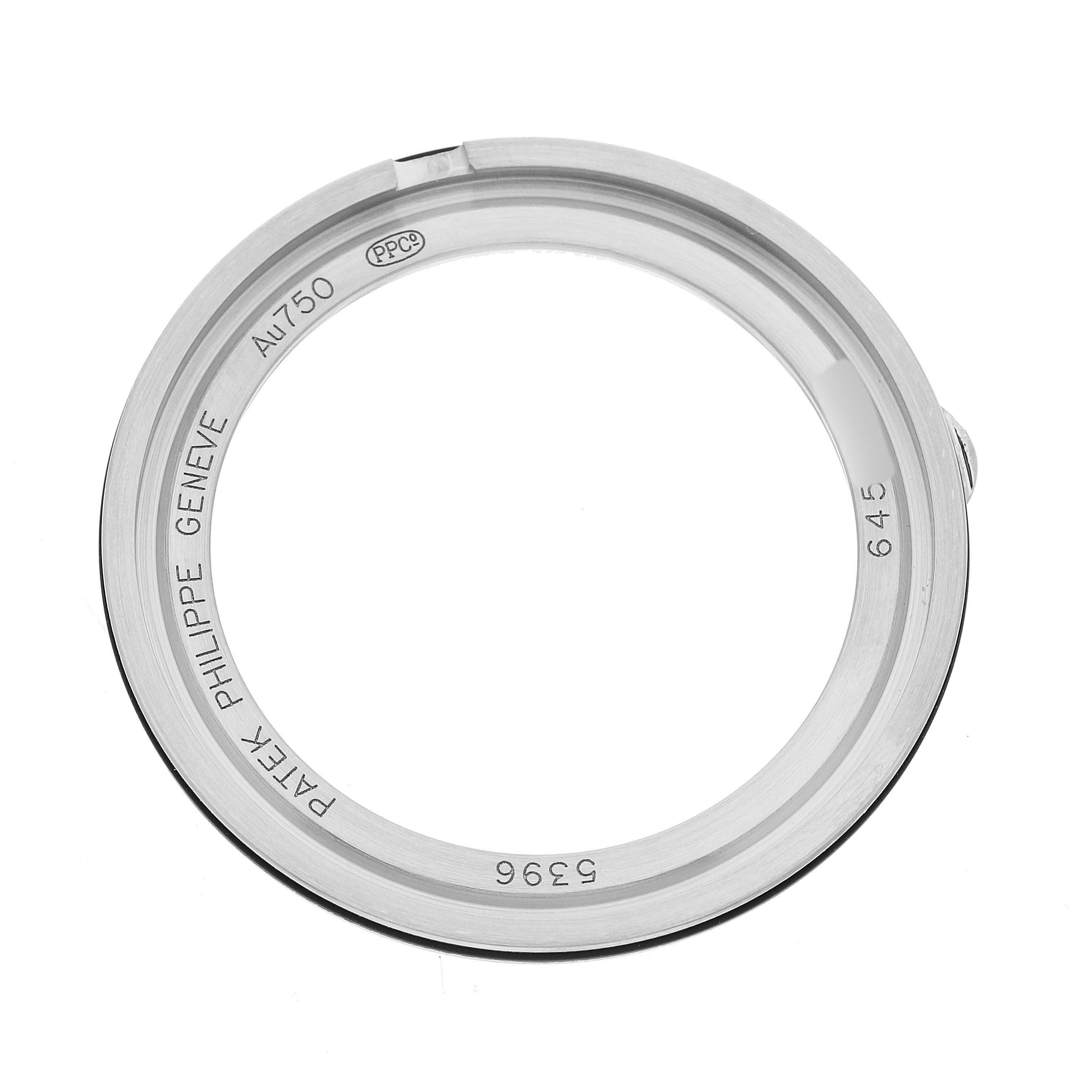The image shows the metal case back of a Patek Philippe Complications 5396G Men's White Gold Silver Dial watch, viewed from above with engraved details visible.