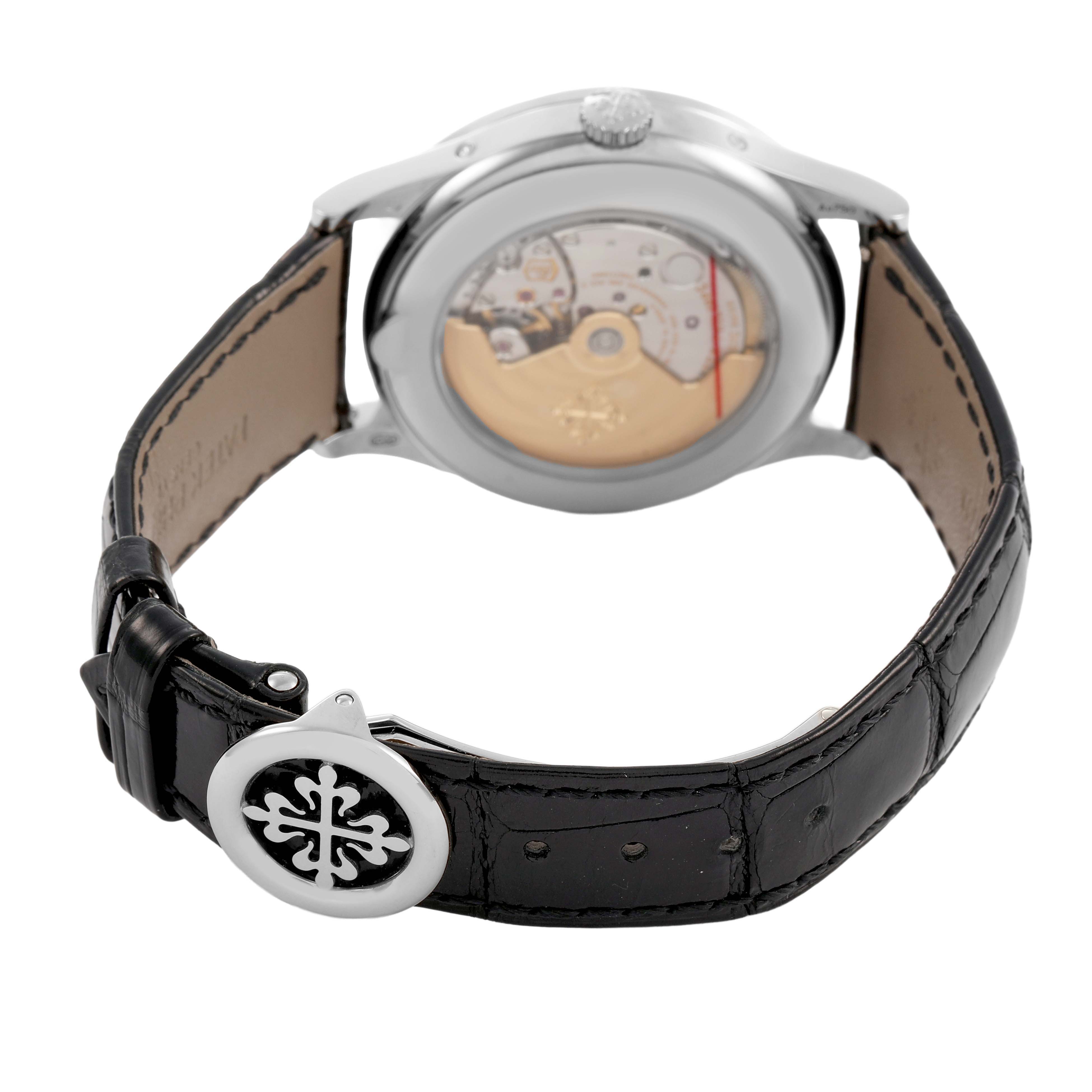 The Patek Philippe Complications 5396G Men's White Gold Silver Dial watch is shown from the back, highlighting its movement and leather strap with buckle.
