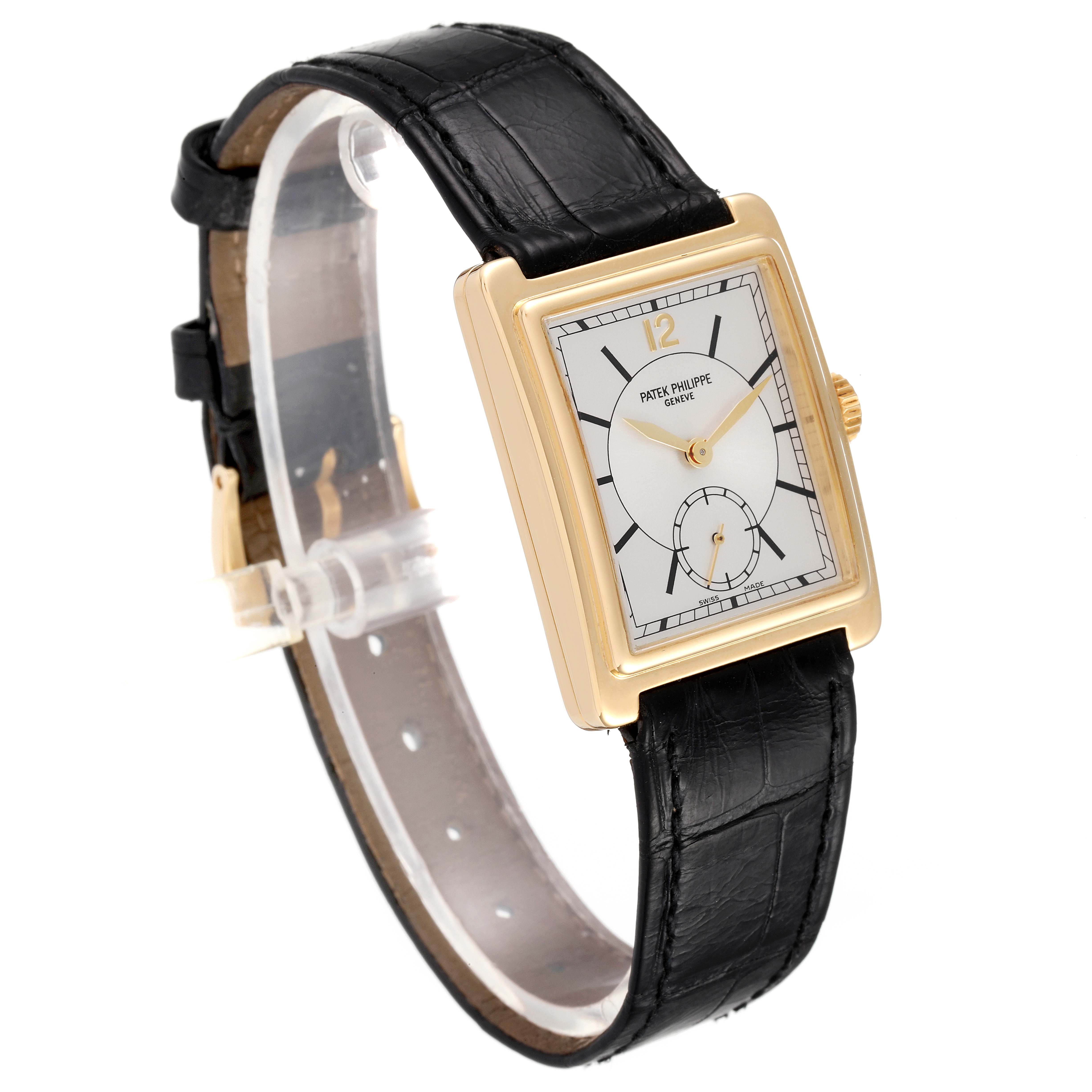 The image shows a side view of the Patek Philippe Gondolo 5010J Men
s Yellow Gold Silver Dial 5010J Men
s Yellow Gold Silver Dial watch, featuring a rectangular gold case and a black leather strap.