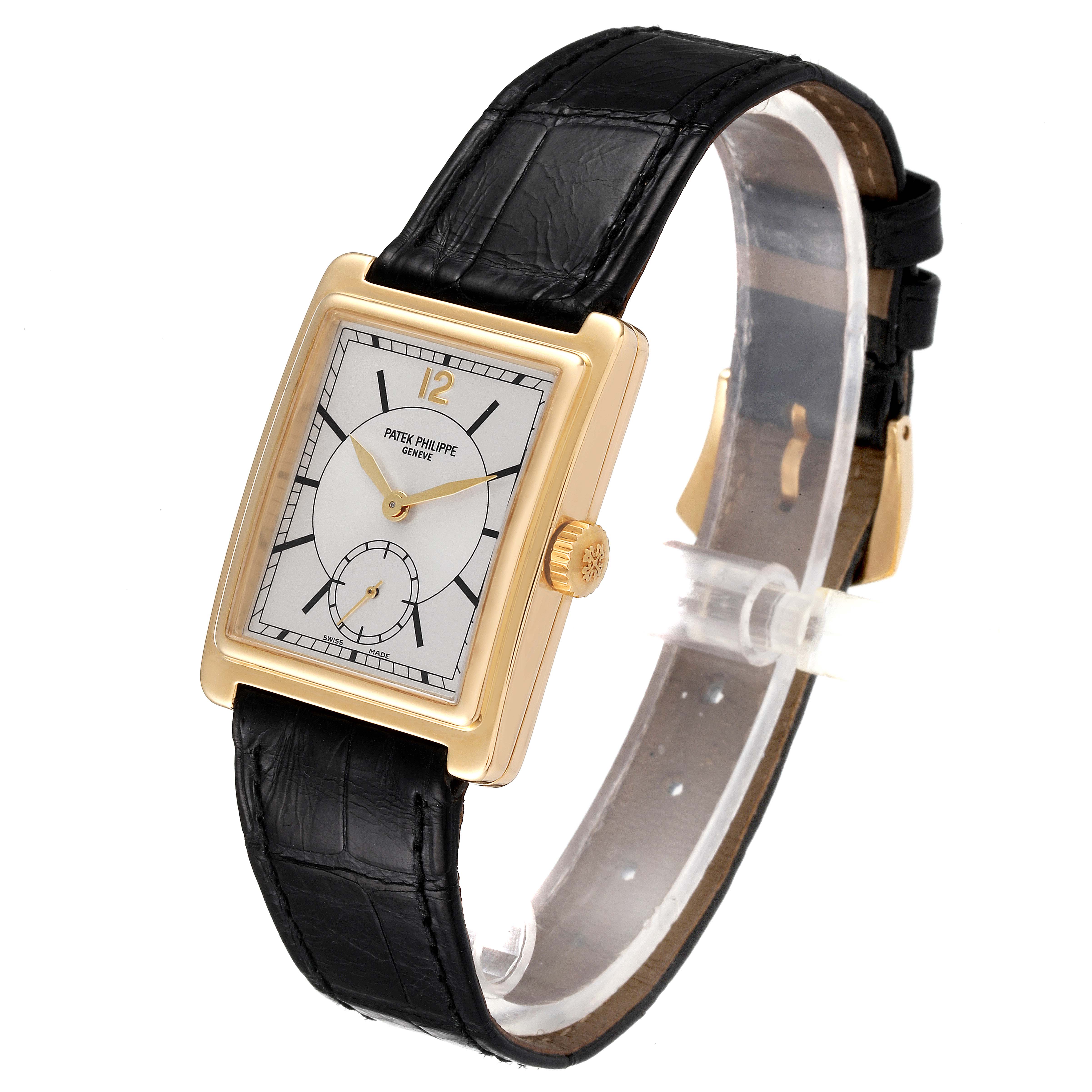 The image shows a Patek Philippe Gondolo 5010J Men
s Yellow Gold Silver Dial 5010J Men
s Yellow Gold Silver Dial watch from an angled view, highlighting its rectangular case, dial, and black leather strap.