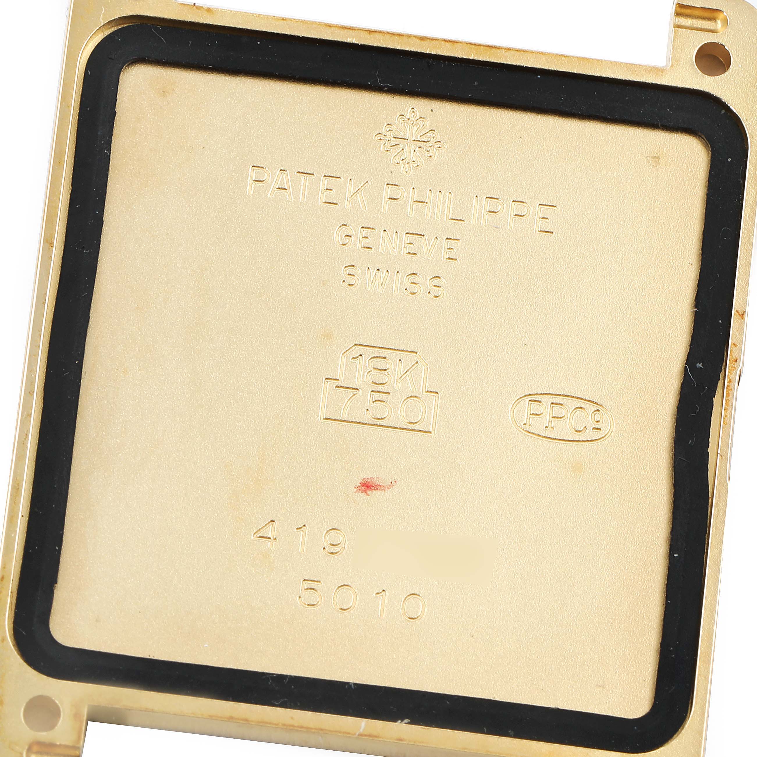 This image shows the inner case back of a Gondolo model watch by Patek Philippe, highlighting the brand markings and gold purity stamp.