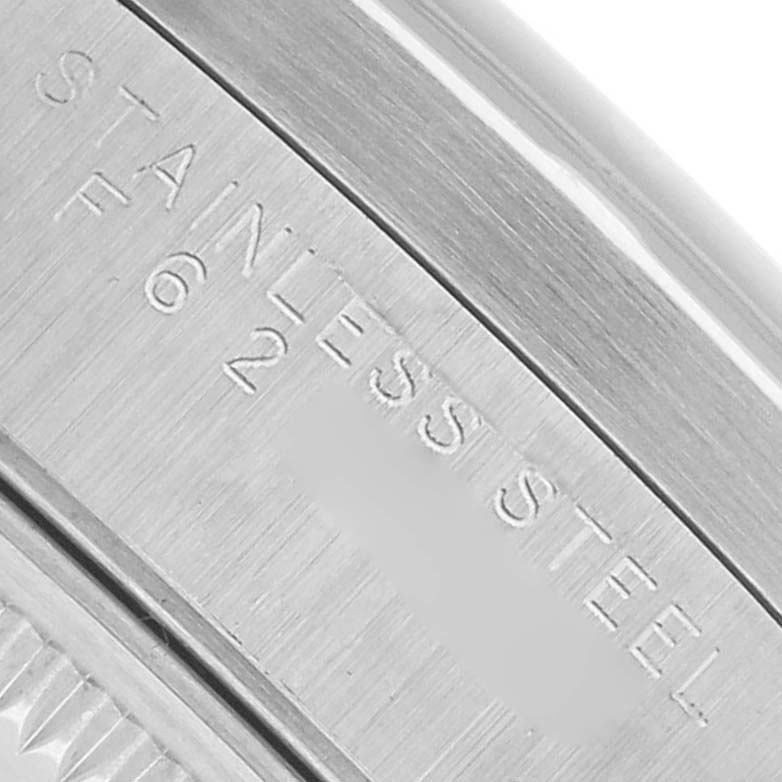 The image shows a close-up of the case back edge of the Rolex Date 15210 Men's Stainless Steel Silver Dial model, with "STAINLESS STEEL" engraved.