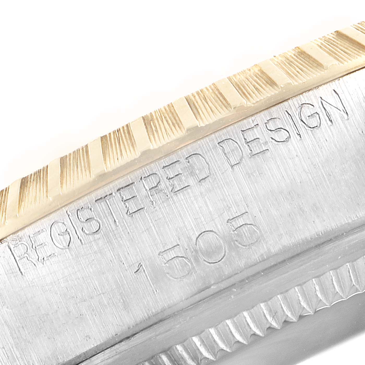 The image shows a close-up of the side of a Vintage Collection model by Rolex, featuring the fluted bezel and engraved details.