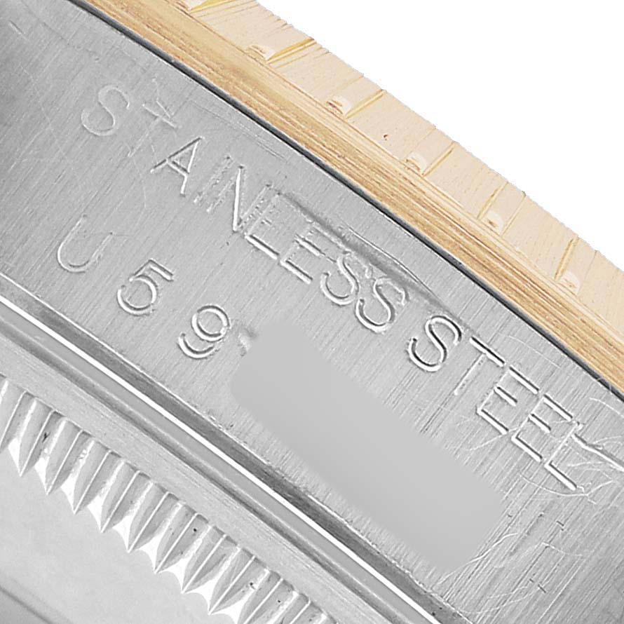 The image shows a close-up of the Rolex Date 15223 Men's Steel and Gold (two tone) Silver Dial model's side, highlighting the stainless steel case and notched bezel.