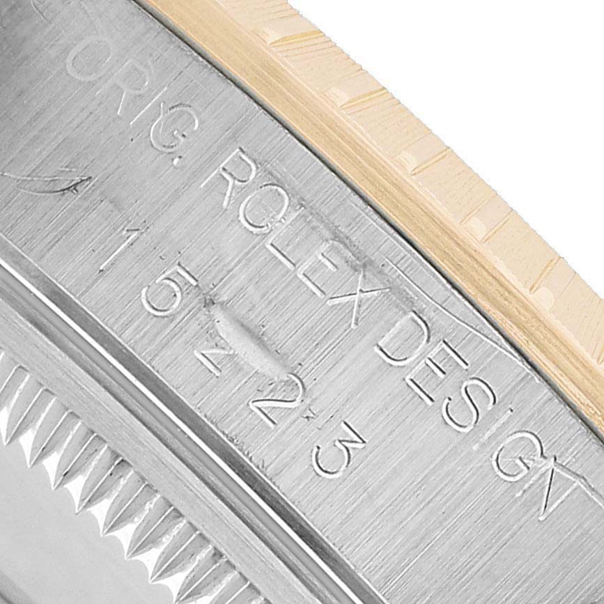 The image shows a close-up of the side engraving on a Rolex Date 15223 Men's Steel and Gold (two tone) Silver Dial model, including "Orig. Rolex Design" and a reference number.
