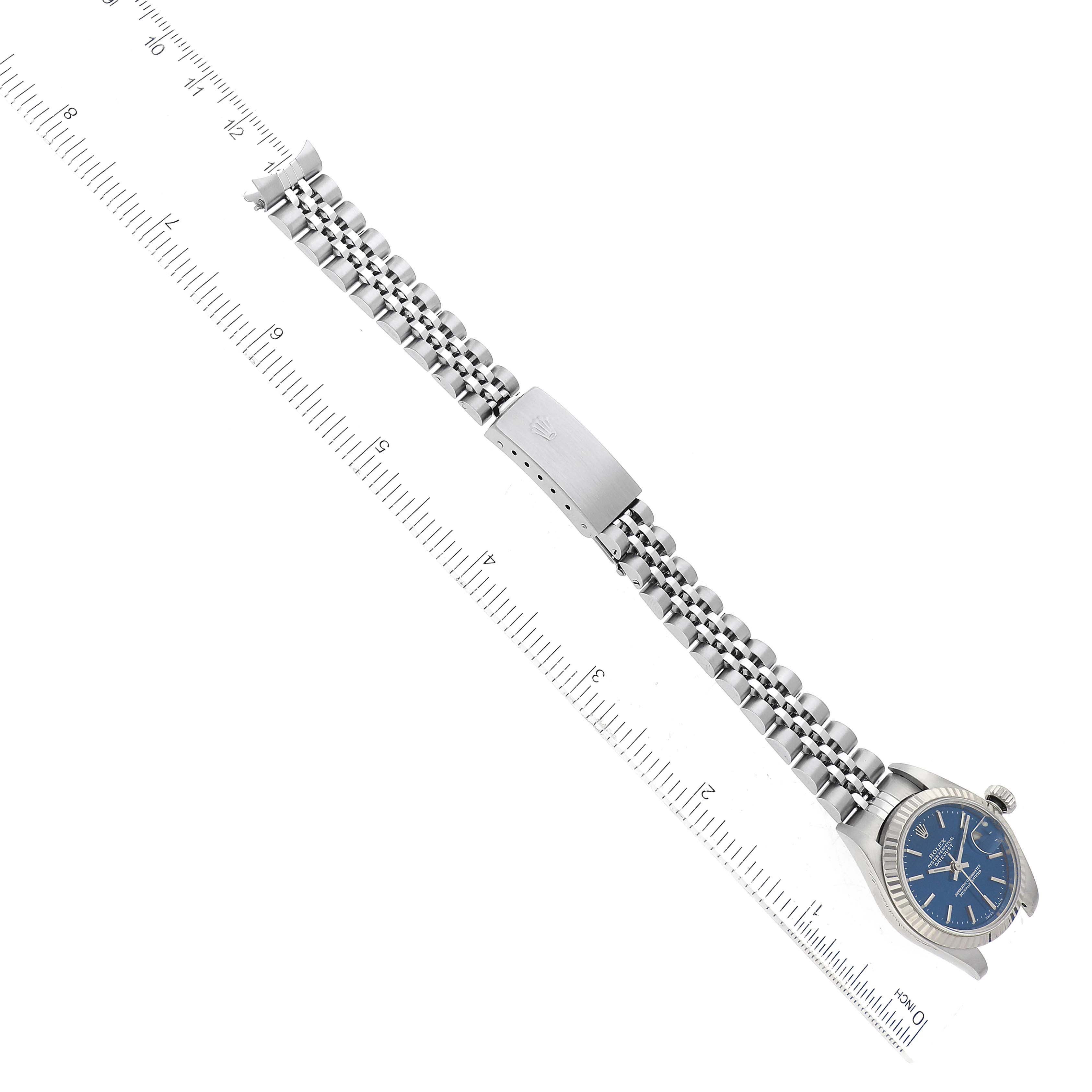 The image shows a top-down view of a Rolex Datejust 79174 Women's Stainless Steel Blue Dial 79174 Women's Stainless Steel Blue Dial watch, displaying the bracelet and blue dial with a ruler for scale.