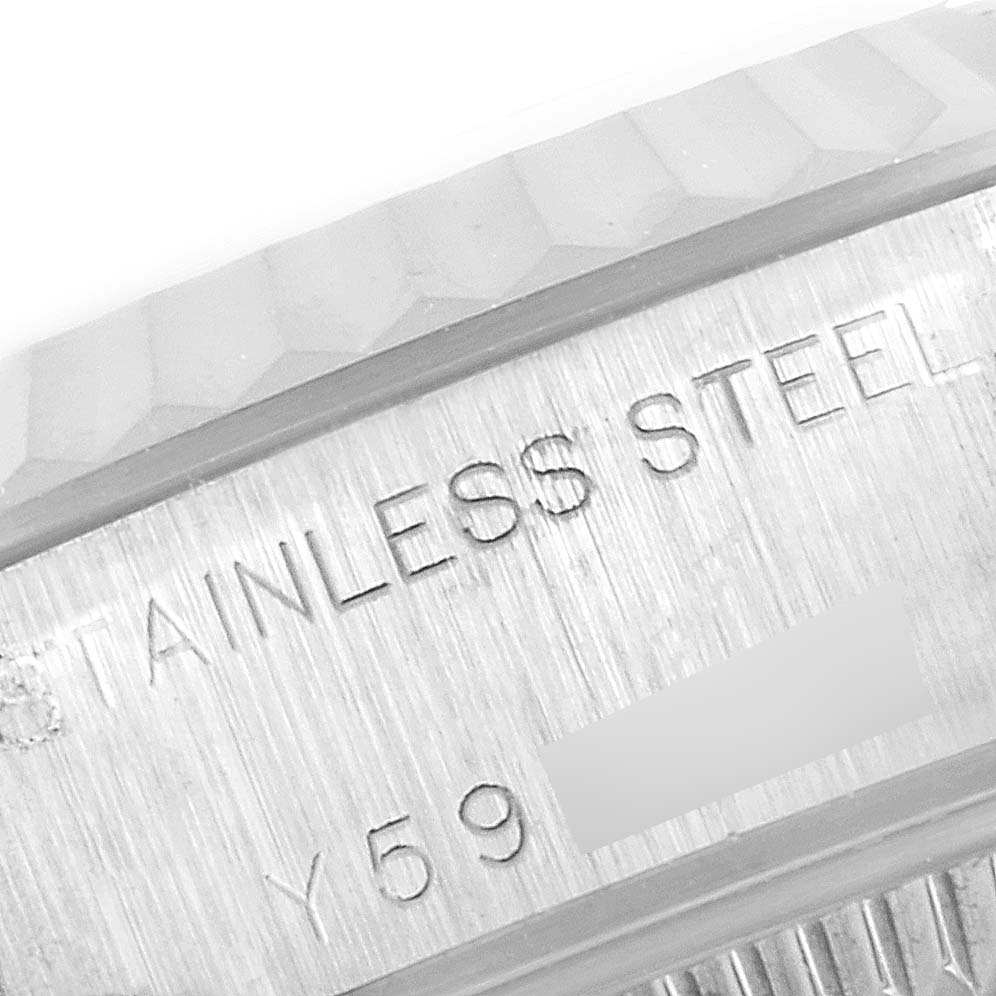 Close-up of the fluted bezel and engravings on the side of a Rolex Datejust 79174 Women
s Stainless Steel Silver Dial 79174 Women
s Stainless Steel Silver Dial watch in stainless steel.