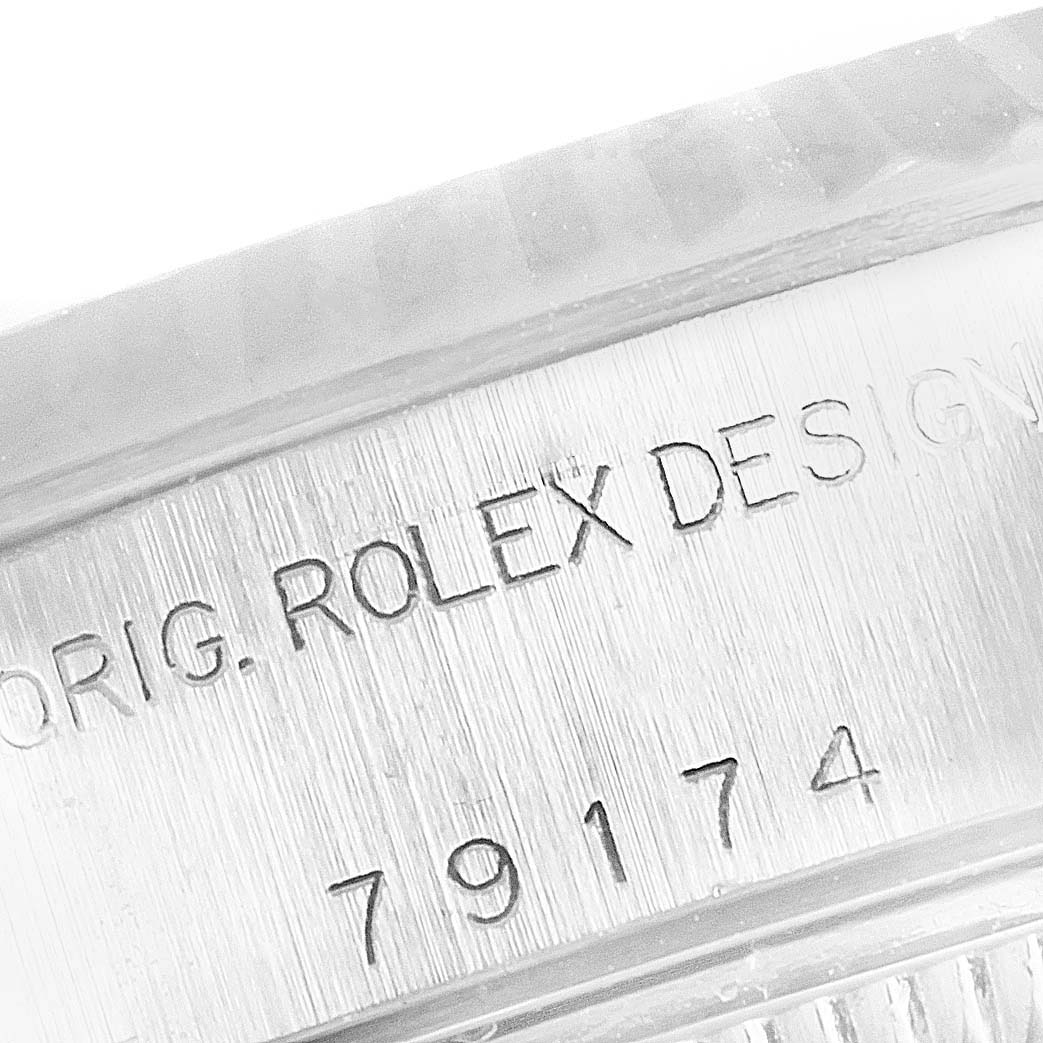 This image shows an inscribed close-up of the case side of a Rolex Datejust 79174 Women
s Stainless Steel Silver Dial 79174 Women
s Stainless Steel Silver Dial watch, displaying the model number.