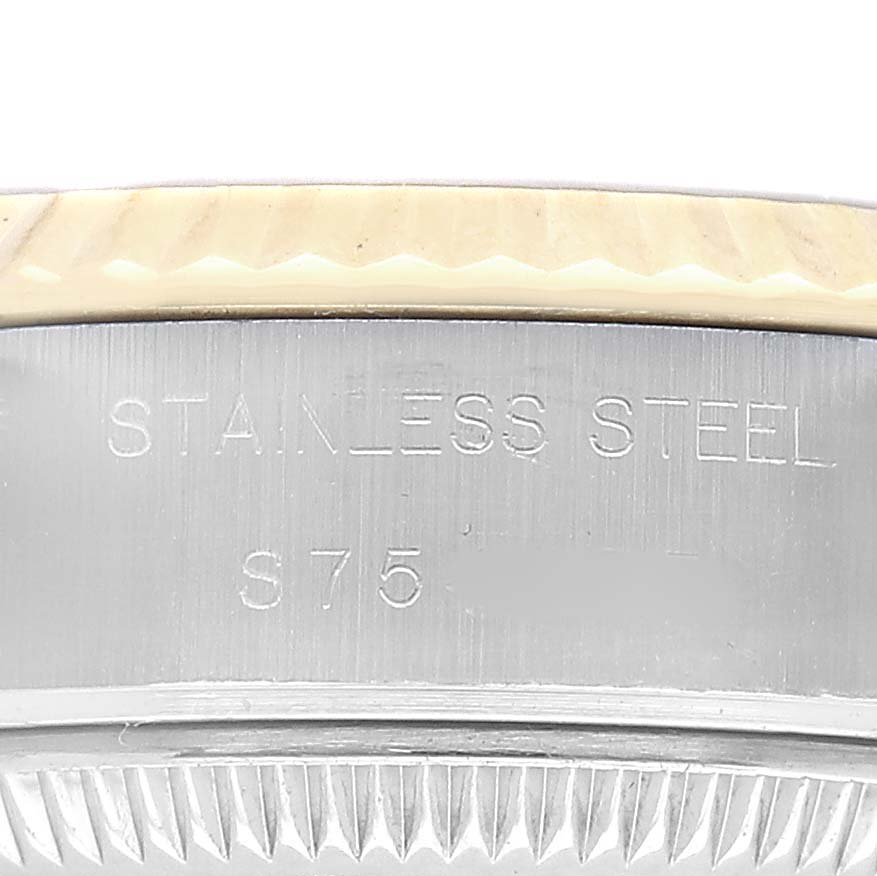 The image shows a close-up of the Rolex Datejust 69173 Women's Stainless Steel Champagne Dial's stainless steel case with engraving visible.