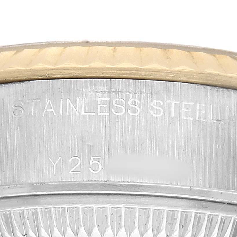 The image shows a close-up of the side view of a Rolex Datejust 79173 Women's Steel and Gold (two tone) Champagne Dial watch case, highlighting the engraving and stainless steel texture.