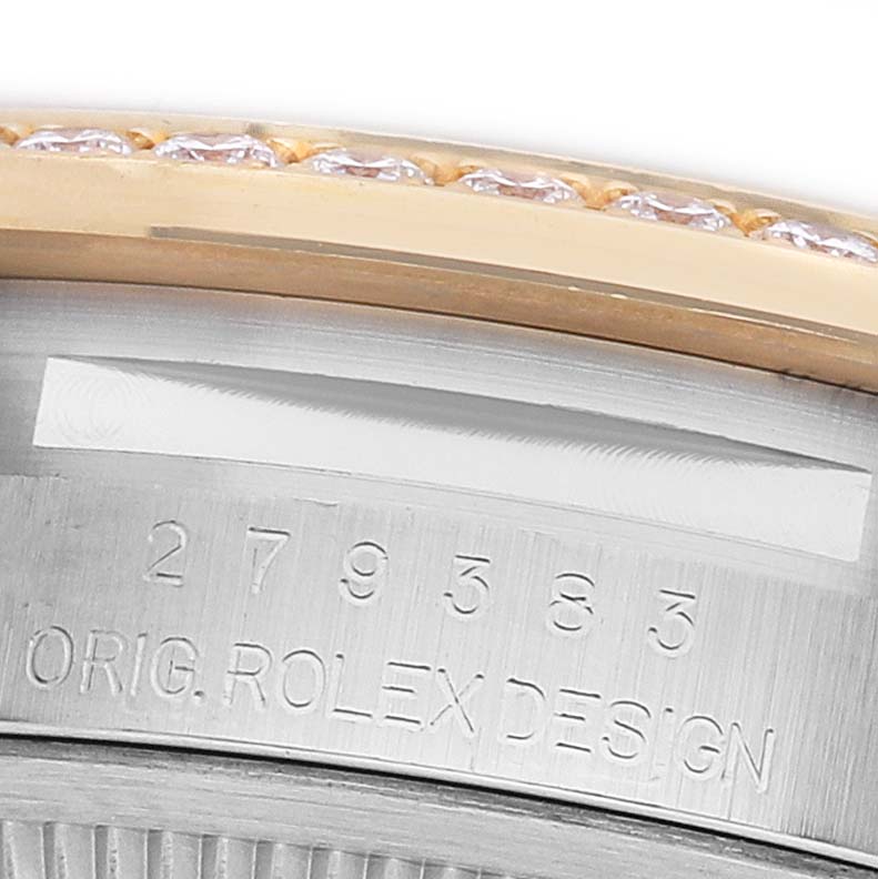 The image shows a close-up of the case side of a Rolex Datejust 279383RBR Women's Steel and Gold (two tone) Green Dial, featuring the serial number and part of the bezel with diamonds.