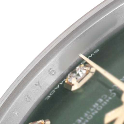 The image shows a close-up of the Rolex Datejust 278383 Women's Steel and Gold (two tone) Green Dial watch dial with a focus on the edge, showing part of the markers and text.