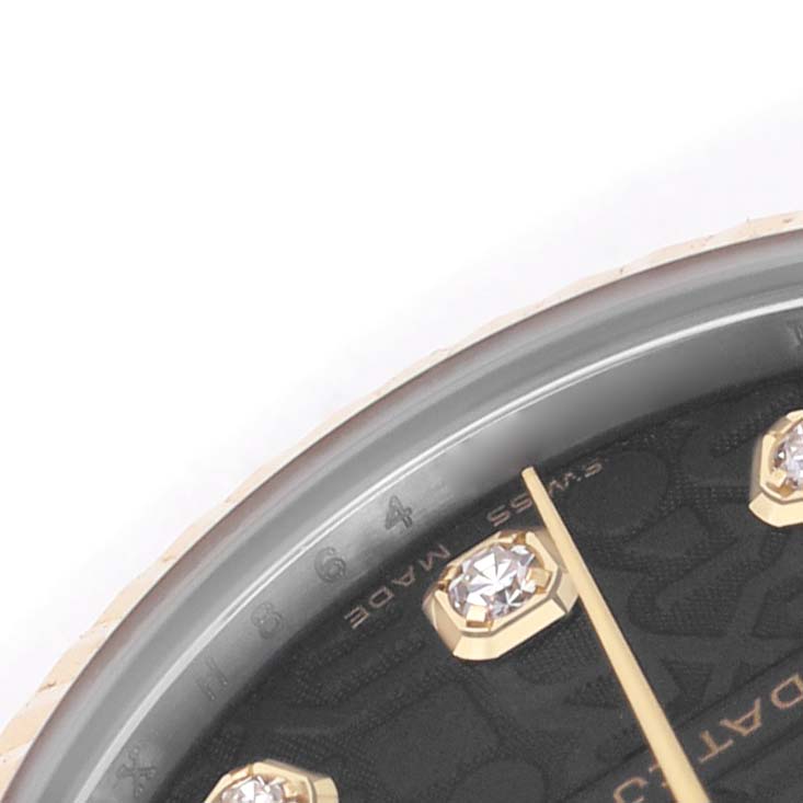 The image shows a close-up of a Rolex Datejust 178273 Women's Stainless Steel Black Dial watch dial, highlighting diamond hour markers and a portion of the watch face.